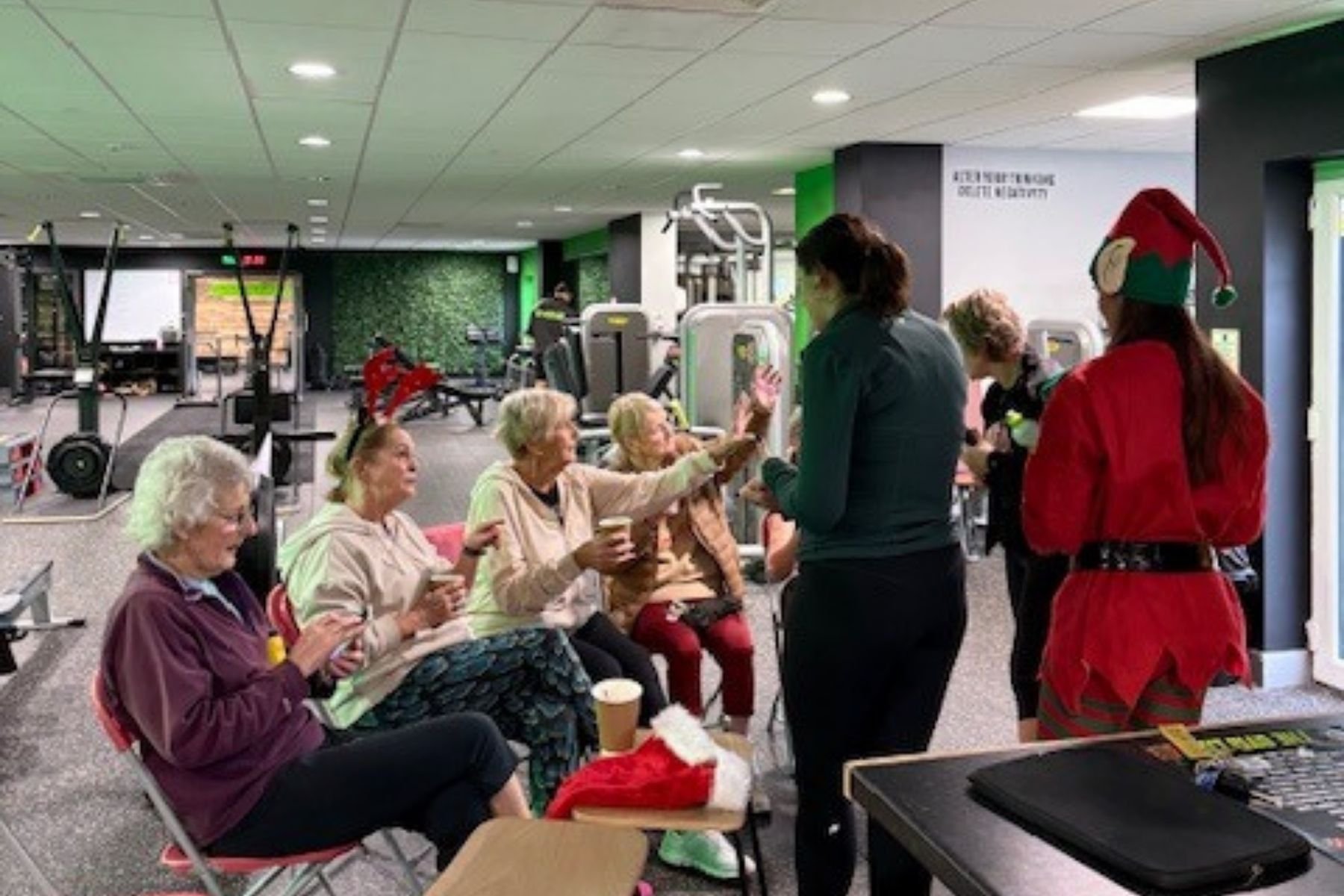 Group of senior members at The Gym lab enjoying a chat and a coffee