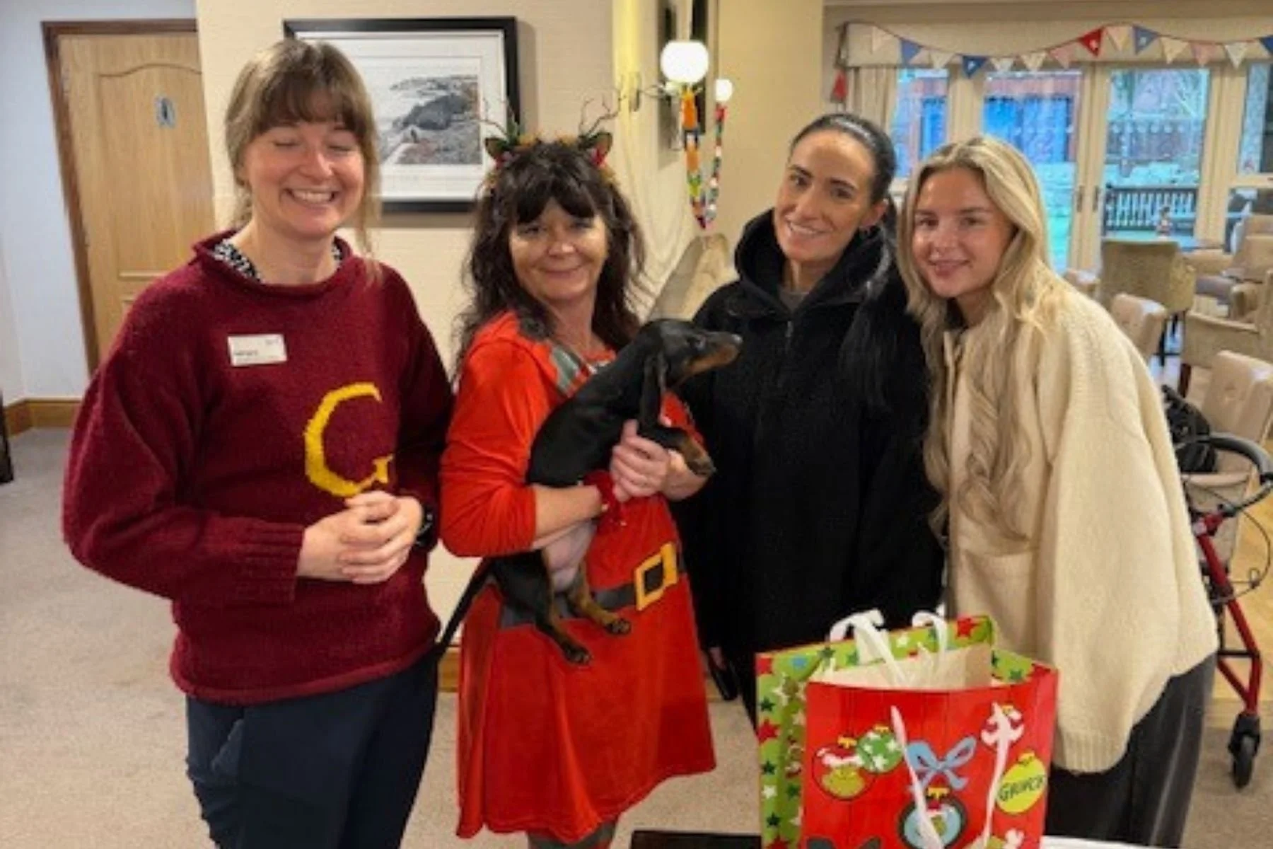 Leila and Emily delivering Christmas presents to a residential care home for the elderly