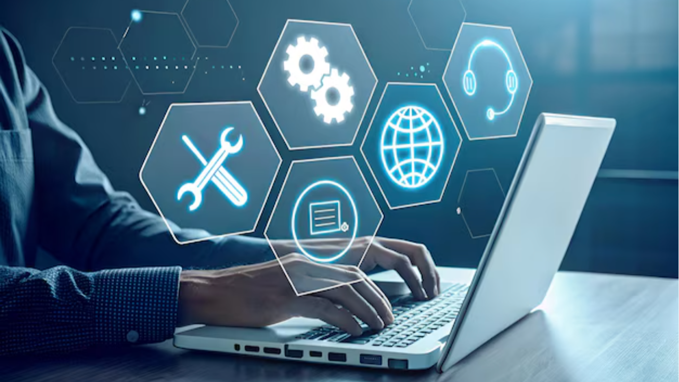 Person typing on a laptop with digital icons representing tools, gears, a globe, a headset, and a document floating above.