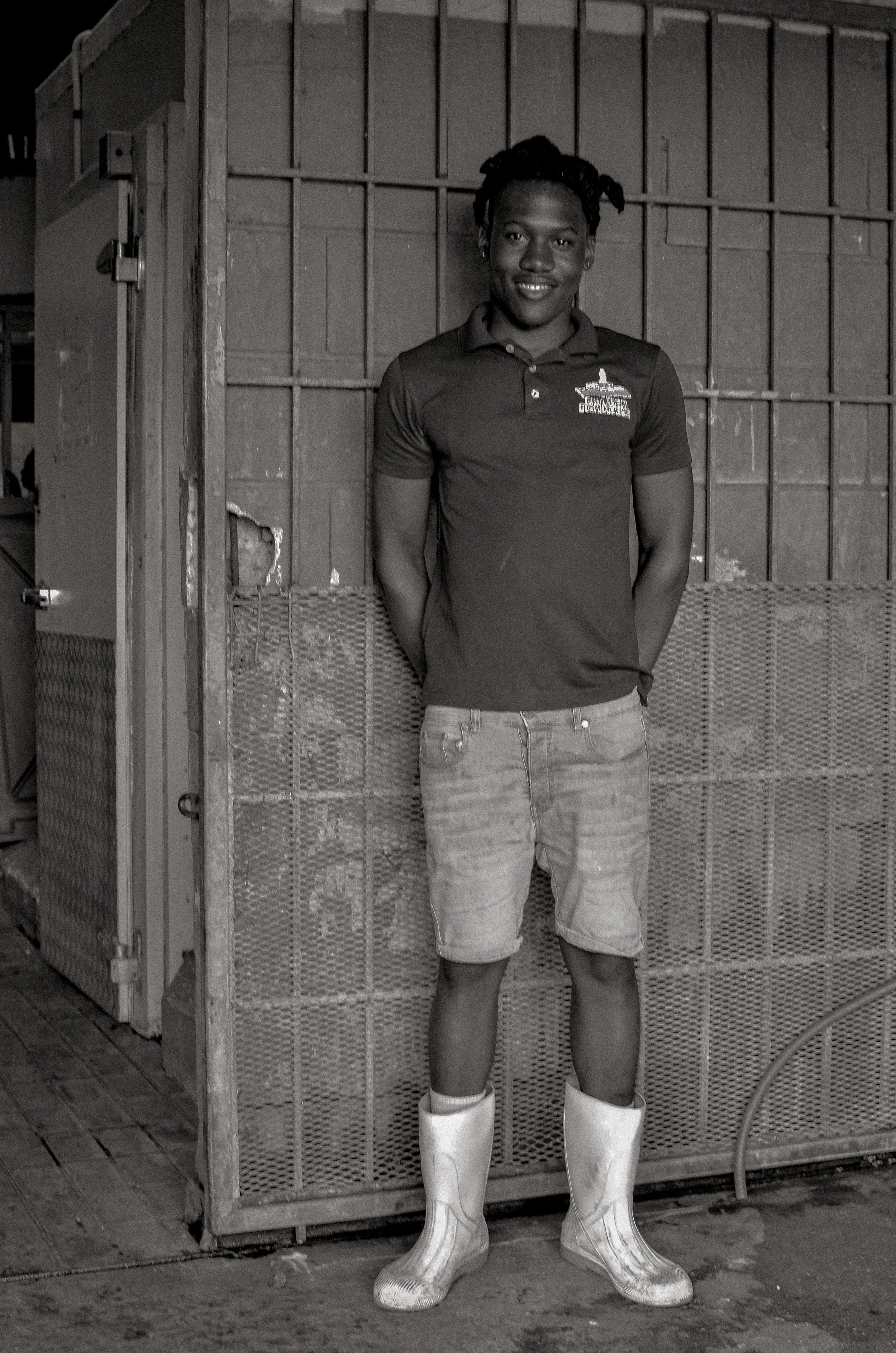 A young fisherman pauses for a portrait at his request. Oistins, Barbados. December 2022.