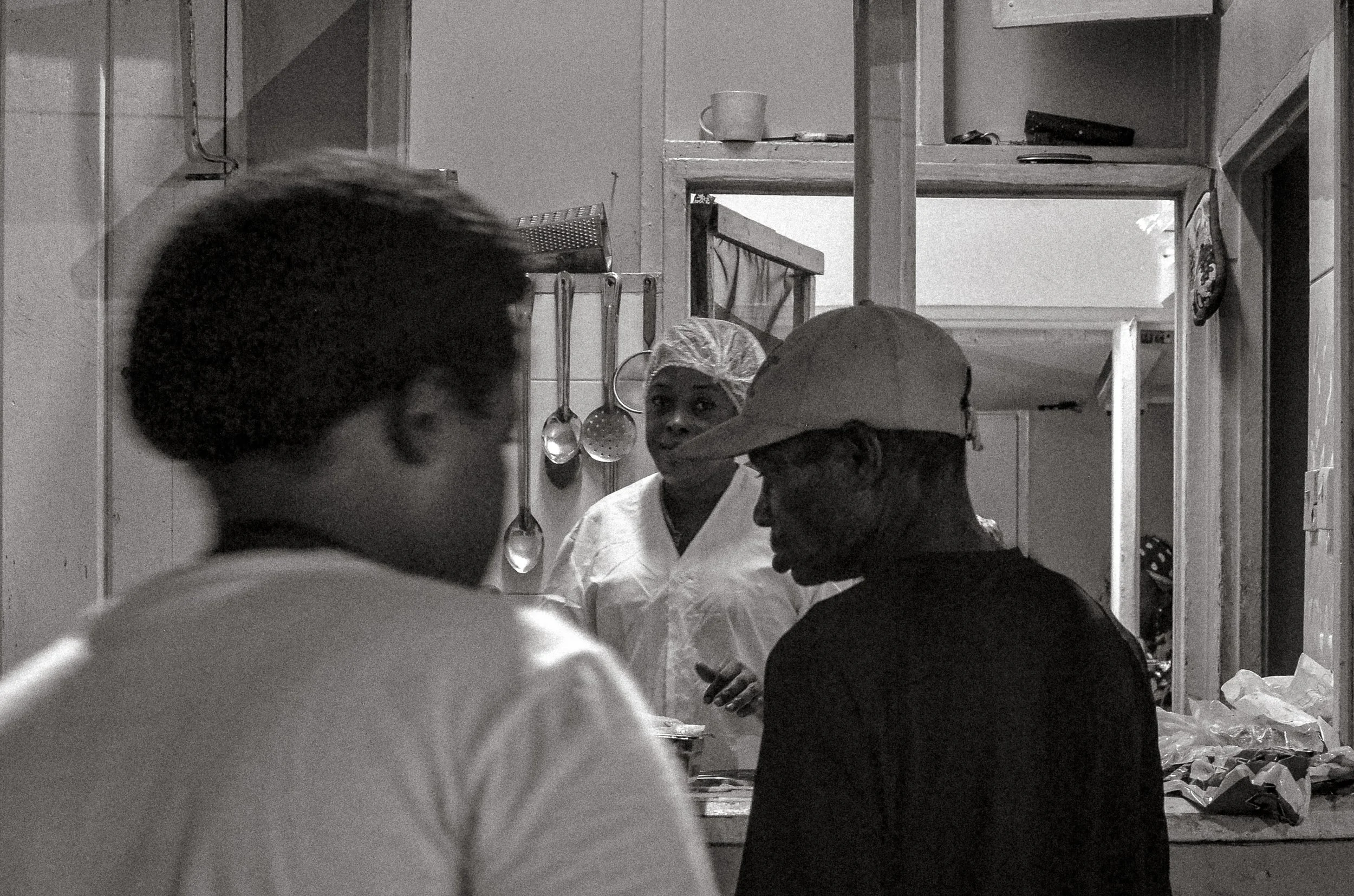 Service begins at the counter as the evening opens. Oistins, Barbados. December 2022.