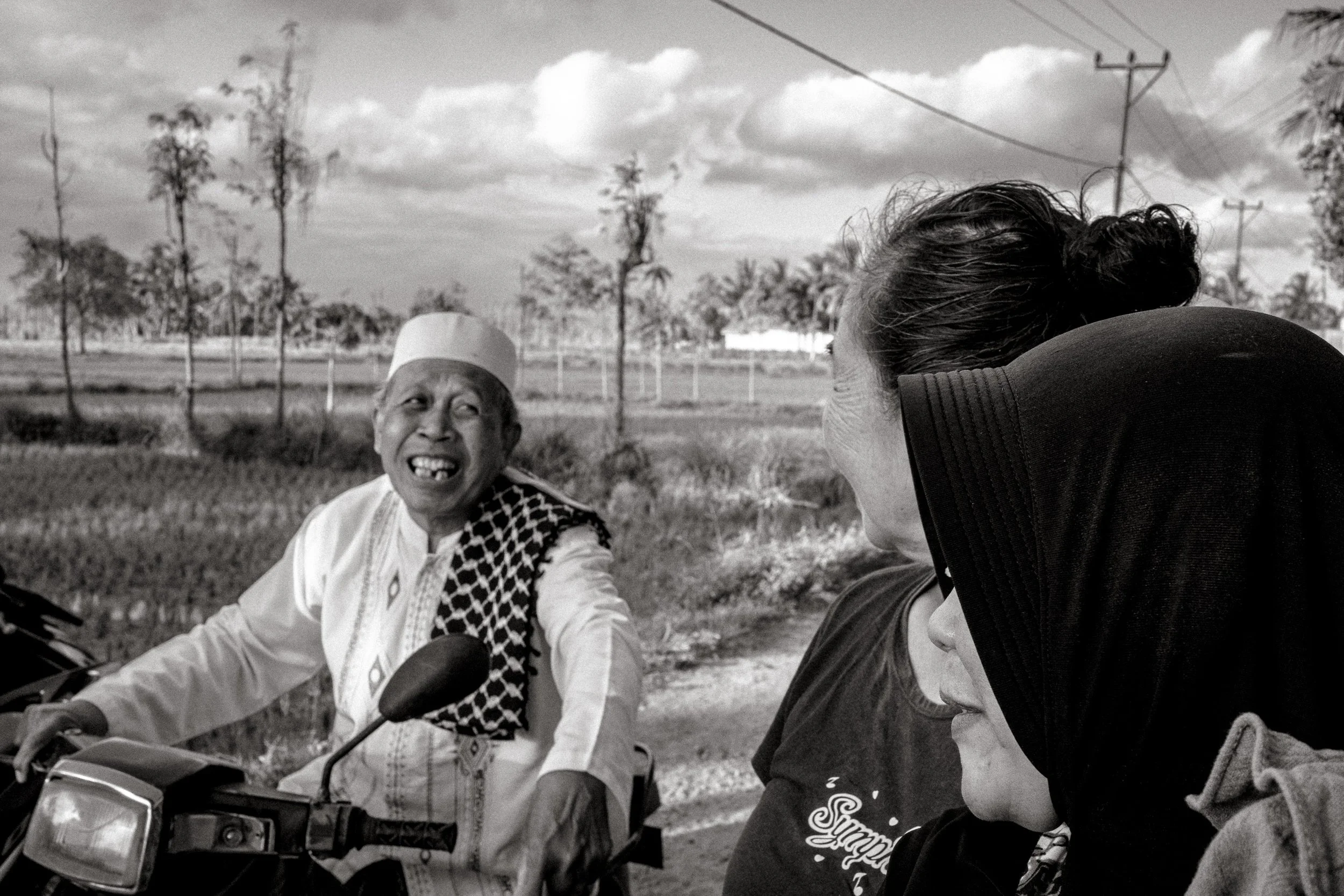Members of the local village converse during the celebration. Central Lombok, Indonesia. 6 August 2025.