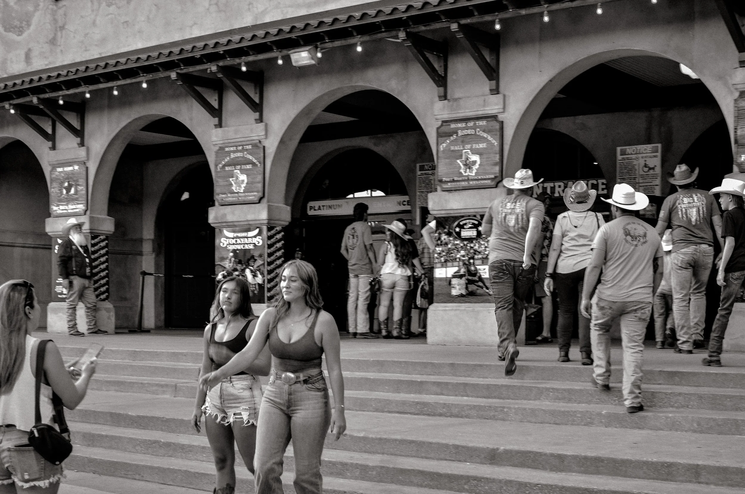 People gather on the steps outside the rodeo entrance. Fort Worth, Texas, USA. 10 August 2023.