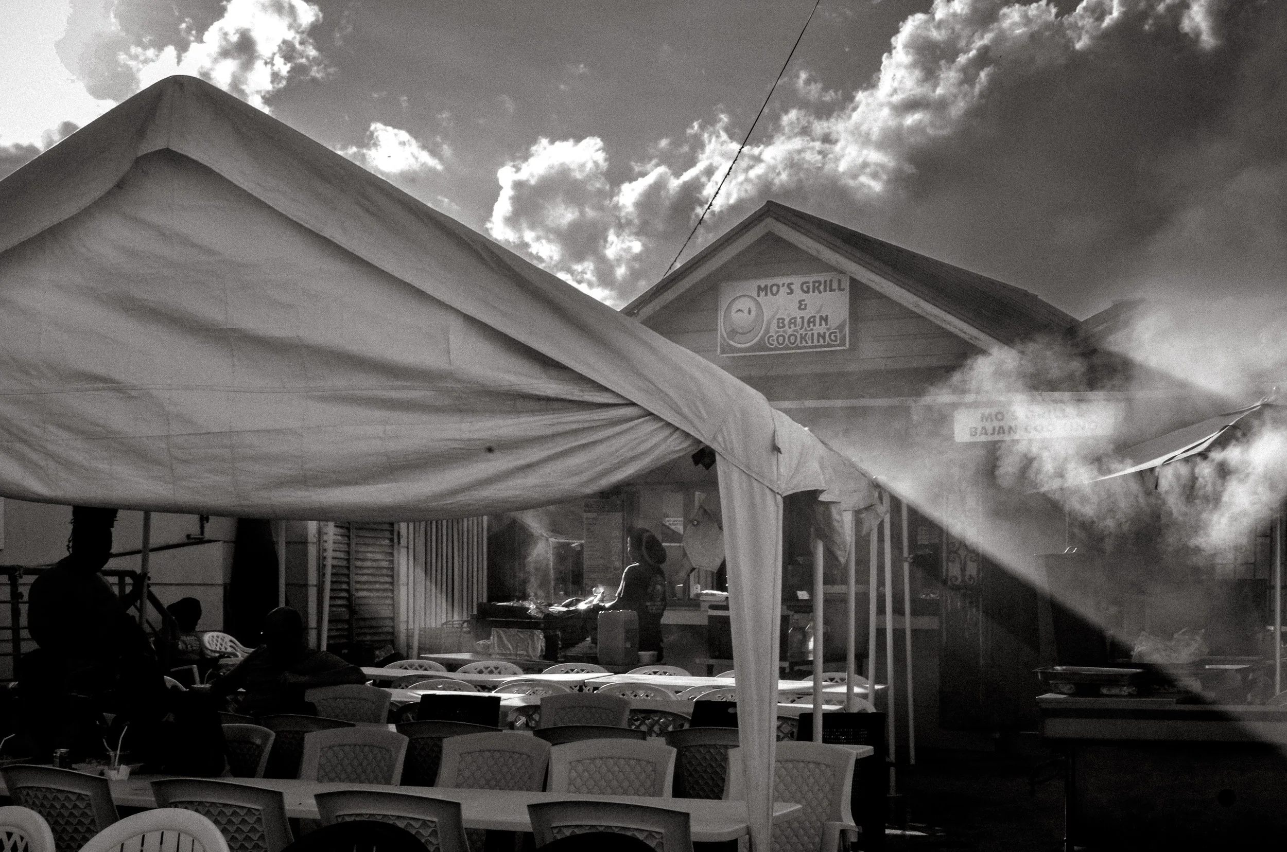 Smoke rises as stalls prepare for the night, before crowds arrive