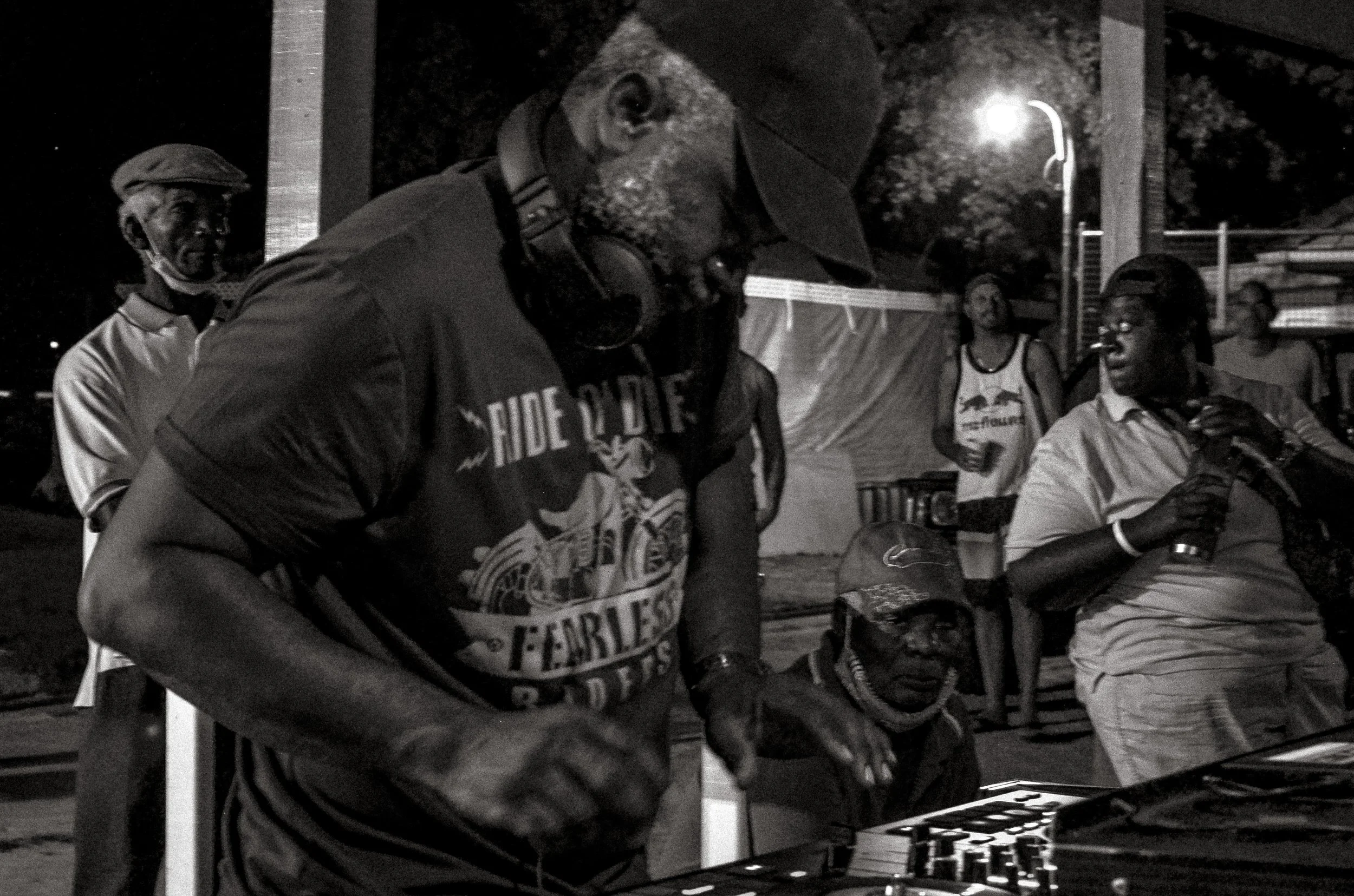 A DJ plays a late-night set after the main rush for a mostly local crowd. Oistins, Barbados. December 2022.