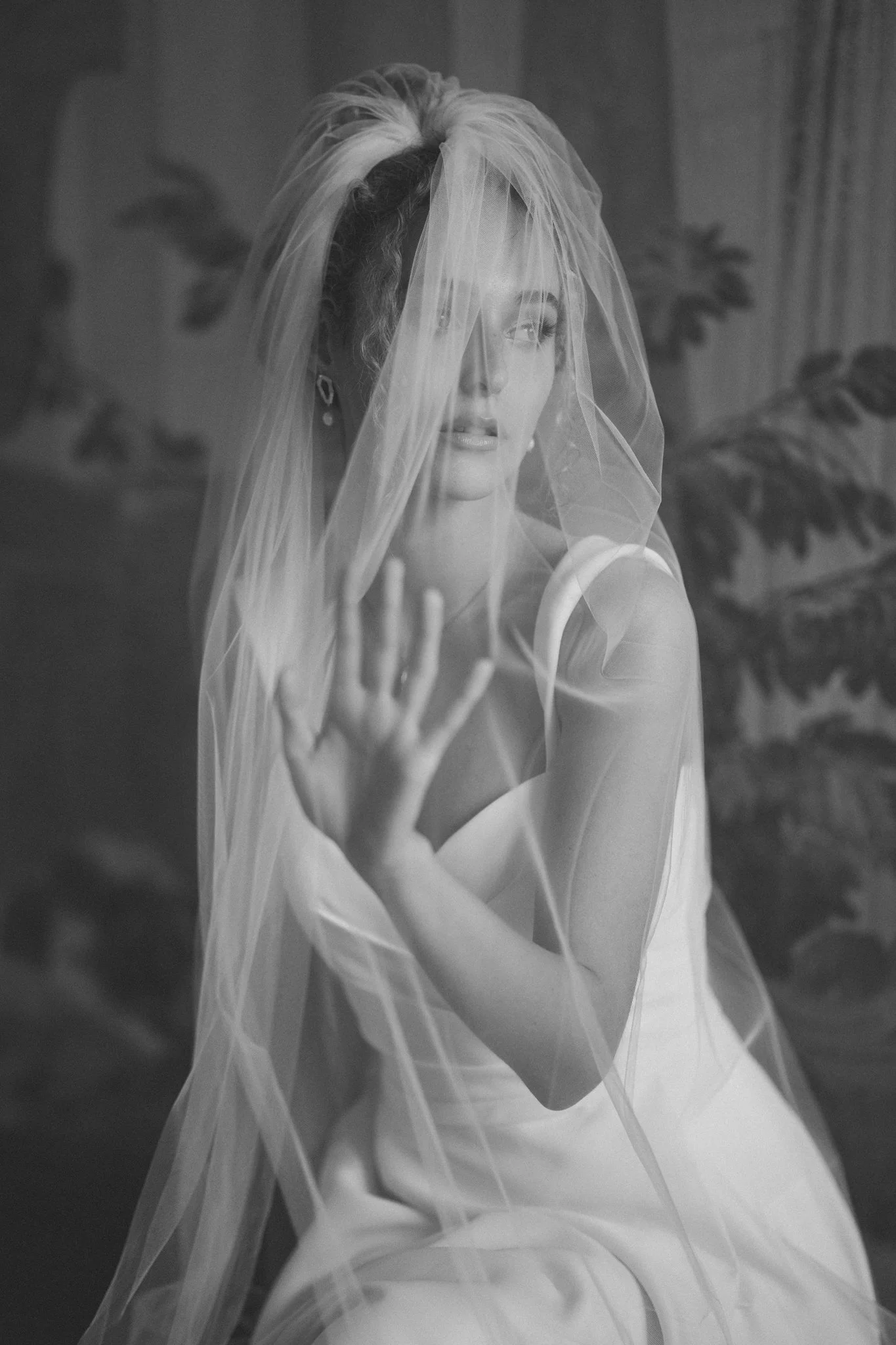 Bride portrait under a wedding veil in soft natural light