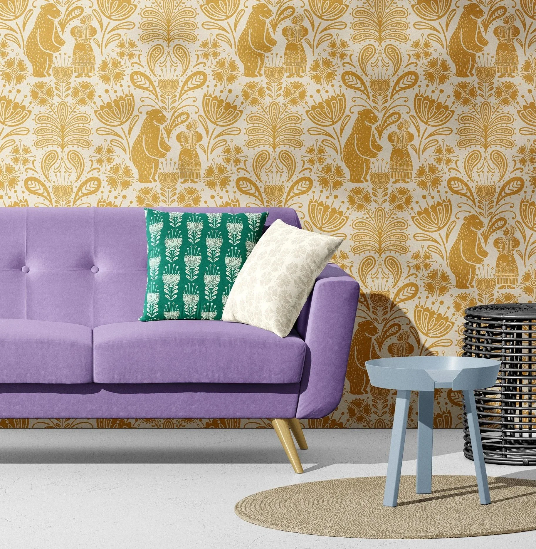 A purple sofa with three decorative pillows in front of a gold and cream patterned wallpaper featuring animals and floral motifs. A light blue small side table and a black round wicker basket are beside the sofa, with a natural fiber rug on white flo