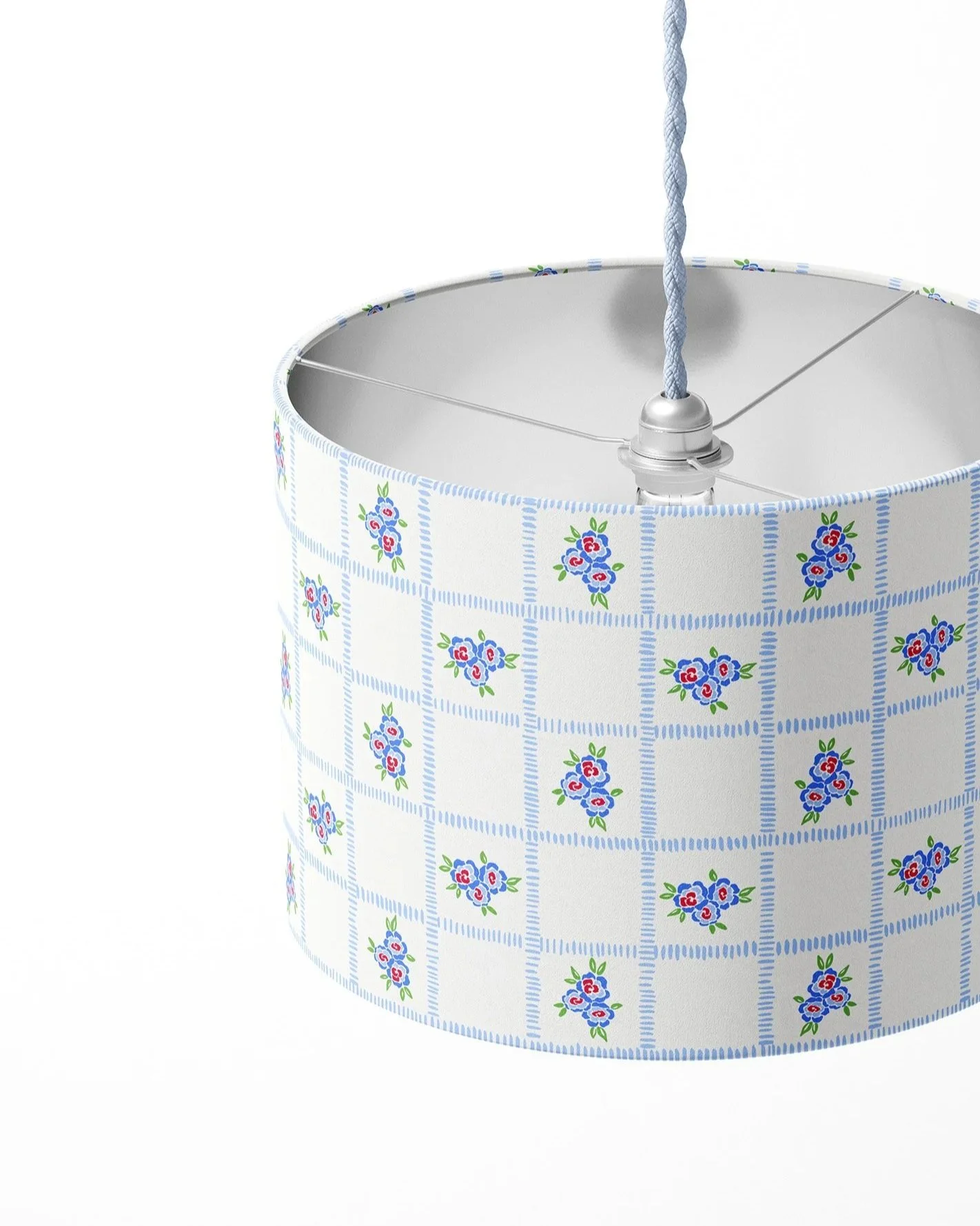 Close-up of a lamp with a floral patterned lampshade, showing the interior wiring and socket