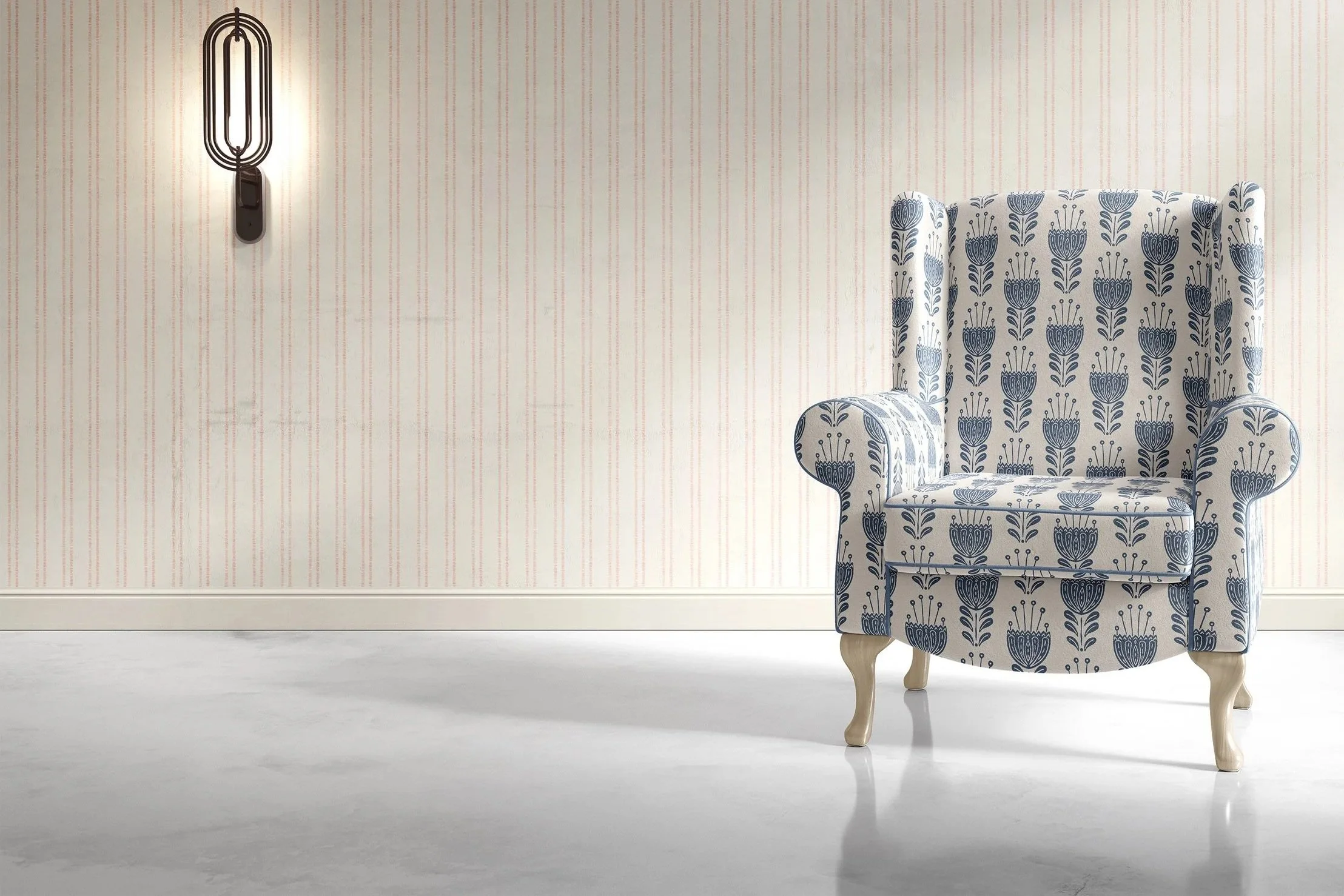 A room with a patterned wallpaper wall, featuring vertical light pink and beige stripes. On the right, there is a vintage-style armchair with a blue floral pattern, wooden legs, and rounded armrests. A modern wall-mounted lamp with an elongated oval 