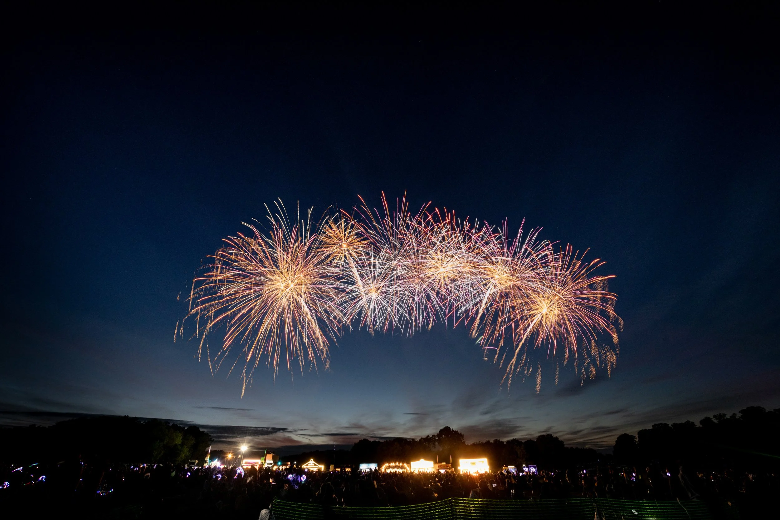 Fireworks exploding in the night sky during a celebration, with a crowd watching below at the National Fireworks Awards hosted at Ragley Hall