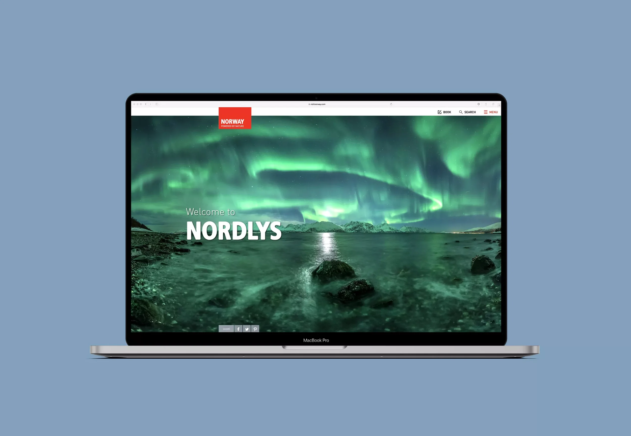 Laptop screen displaying a website about Norway with an image of the Northern Lights over a body of water and mountains, with the title 'Welcome to NORDLYS'.