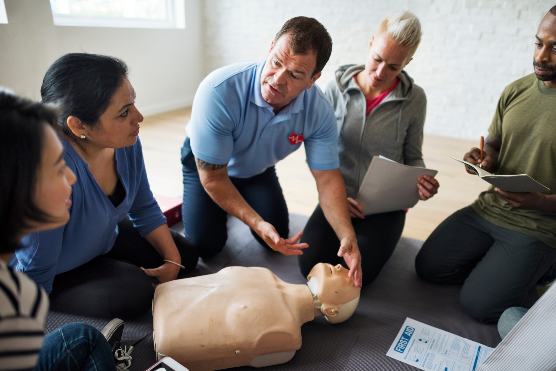 Emergency first aid training taking place in a classroom.