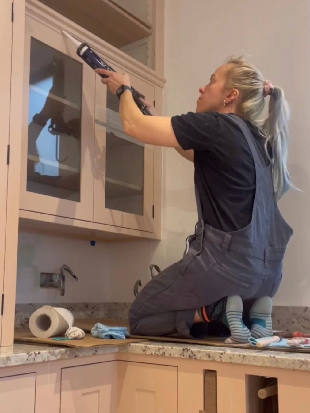 Cabinet joints being caulked and prepared for the final hand‑painted finish