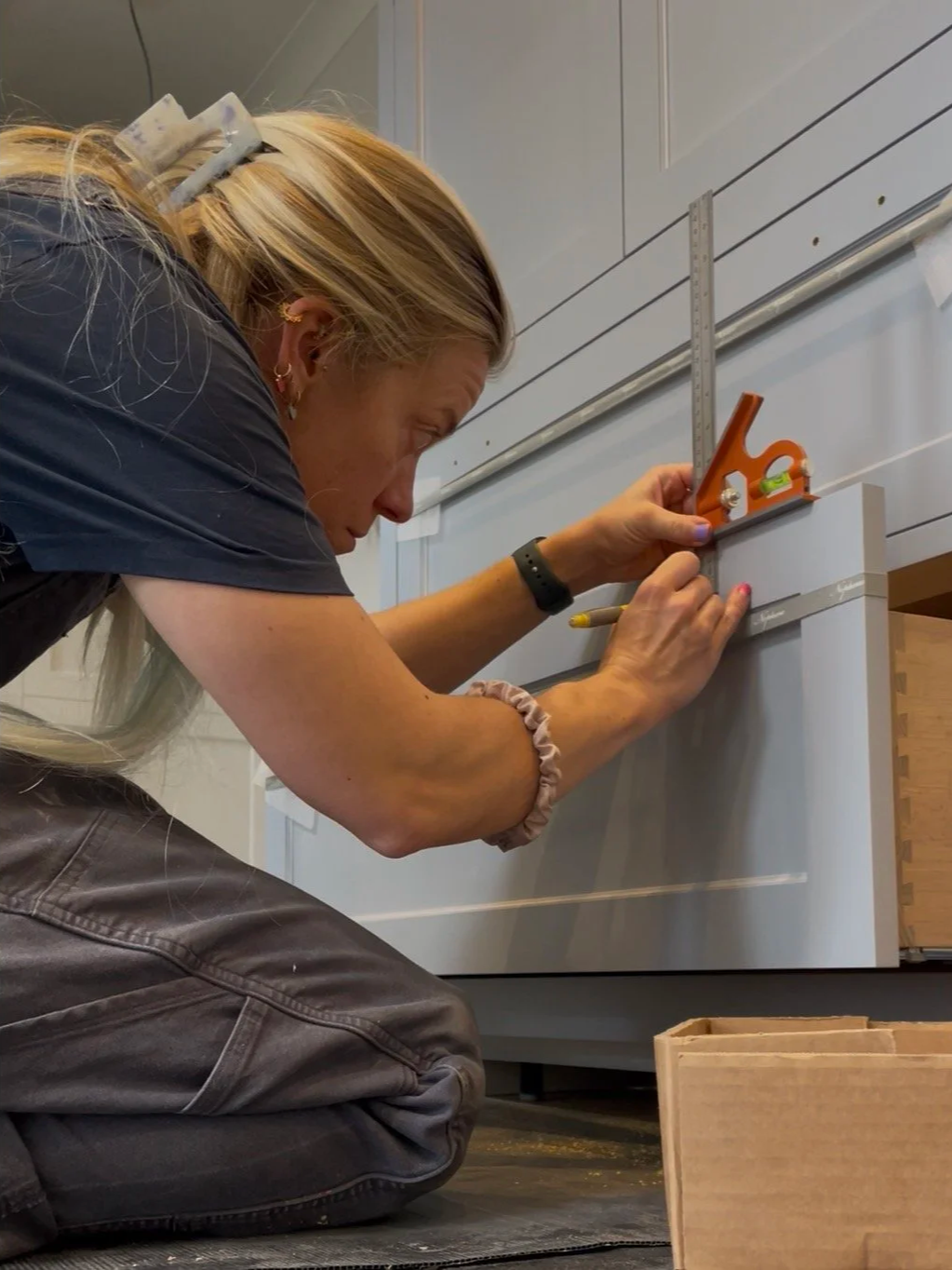 Cabinet handles being carefully measured and marked for handle  fitting