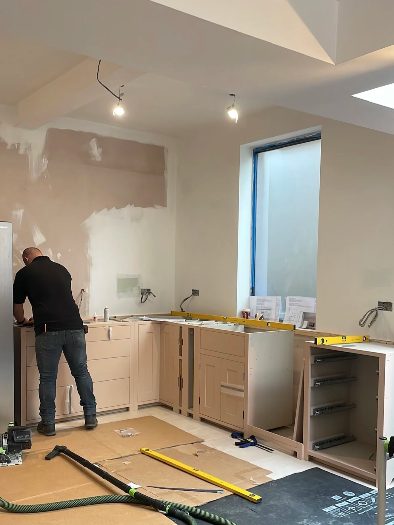 Kitchen cabinets being levelled and adjusted during installation