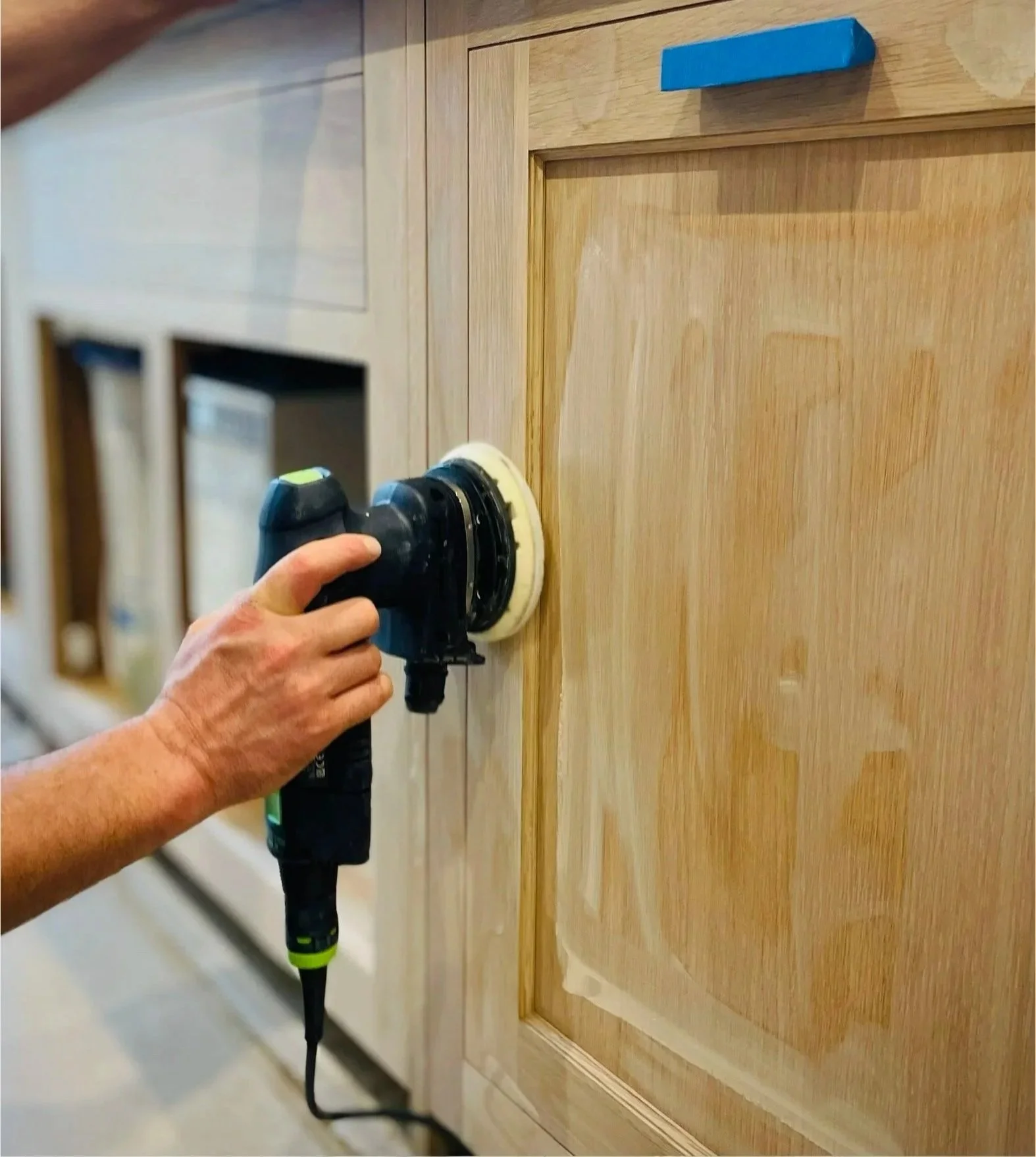 Restoring an oak kitchen cabinet with a new hand‑applied finish, part of our careful bespoke furniture restoration service.