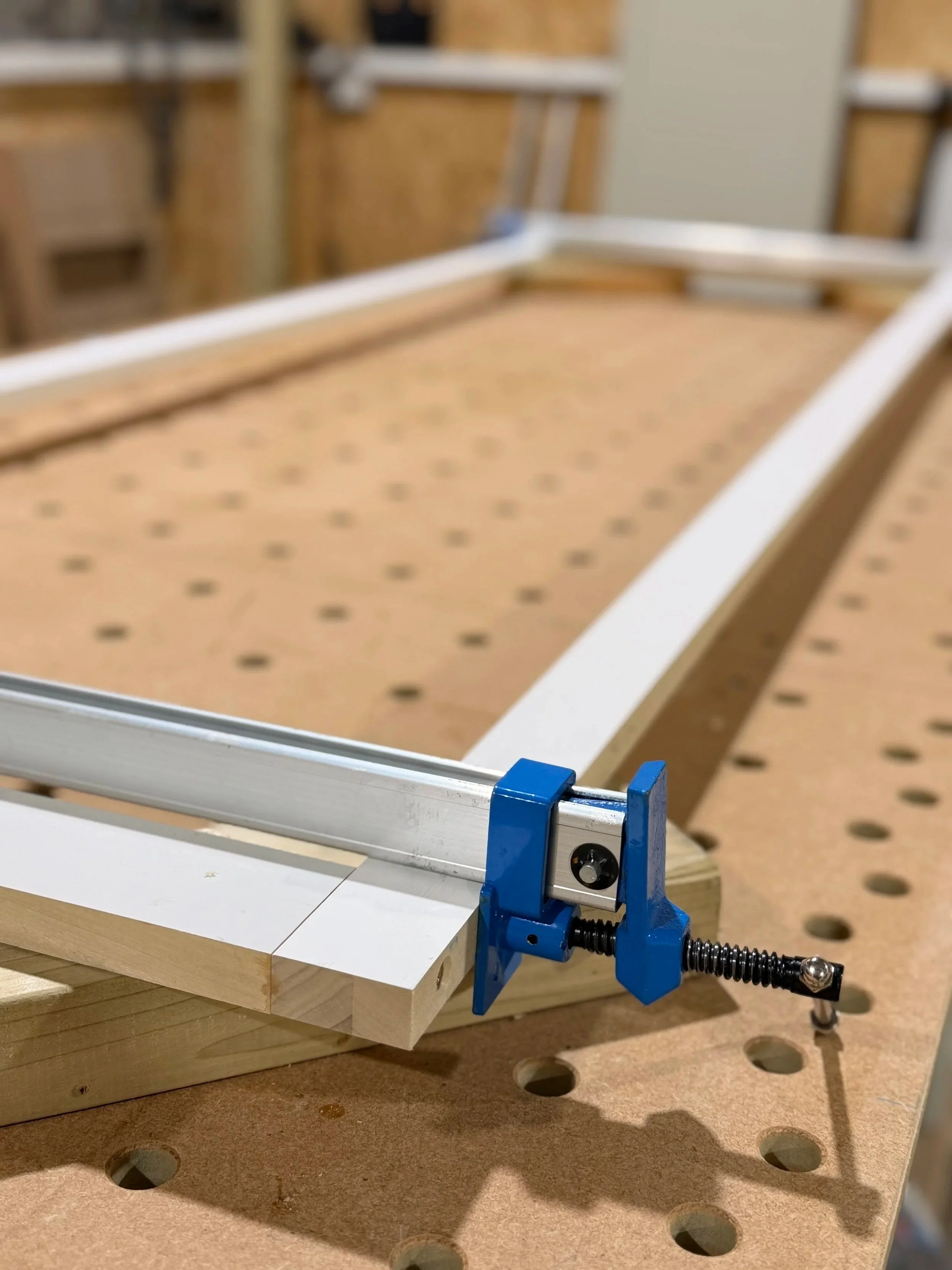 Solid wood frame assembled with dowels, glued, and clamped in the workshop