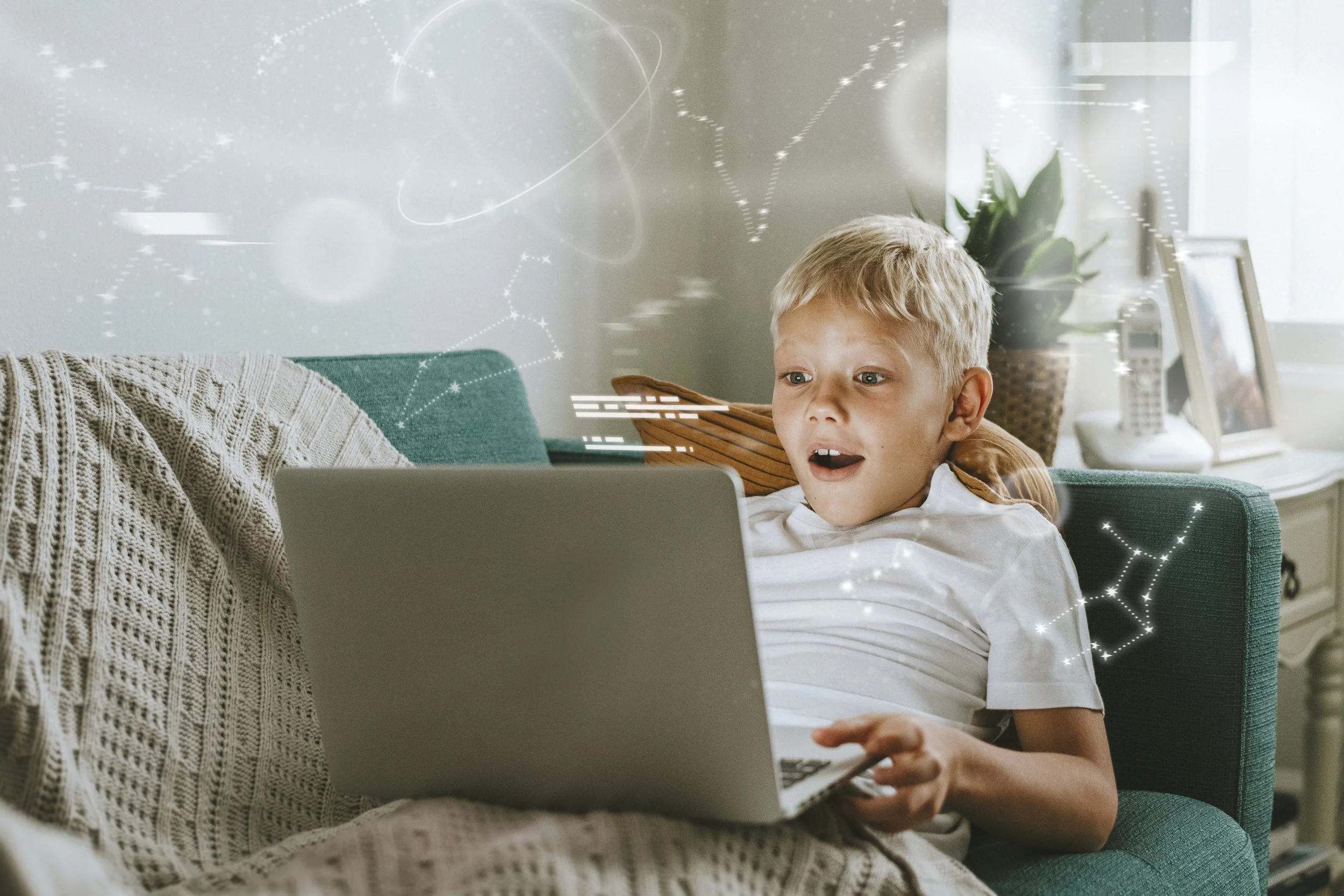 A young boy sitting on a teal couch, looking surprised at a laptop, with constellation graphics overlaid, in a cozy living room.