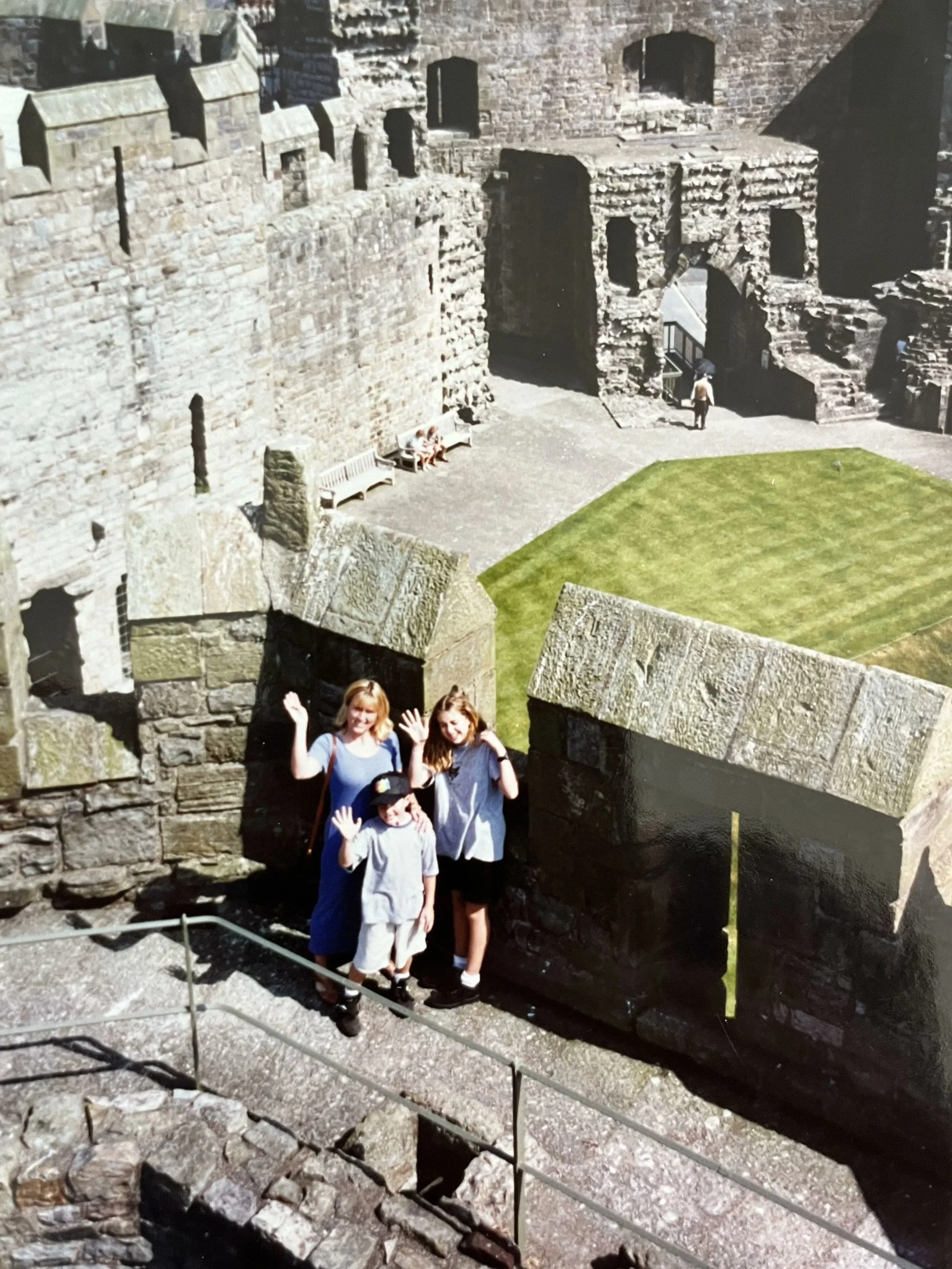 Clementine and her family stand in Caernarvon castle in Wales. One of the inspirational moments that led to Clementine's future as a high-end custom residential architect in Charlotte, NC.