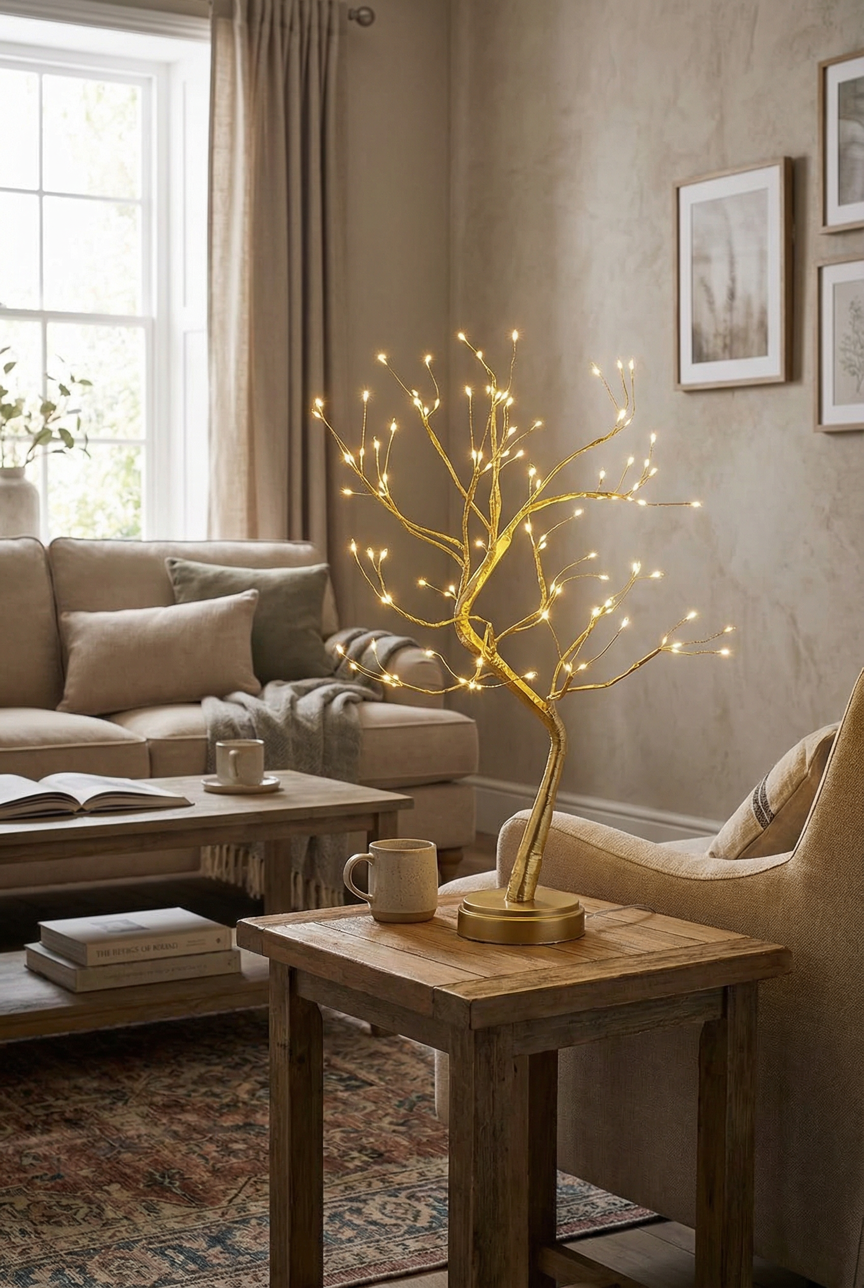 Living room with a beige sofa, wooden coffee table, and decorative branch lamp on a side table, illuminated with warm light.