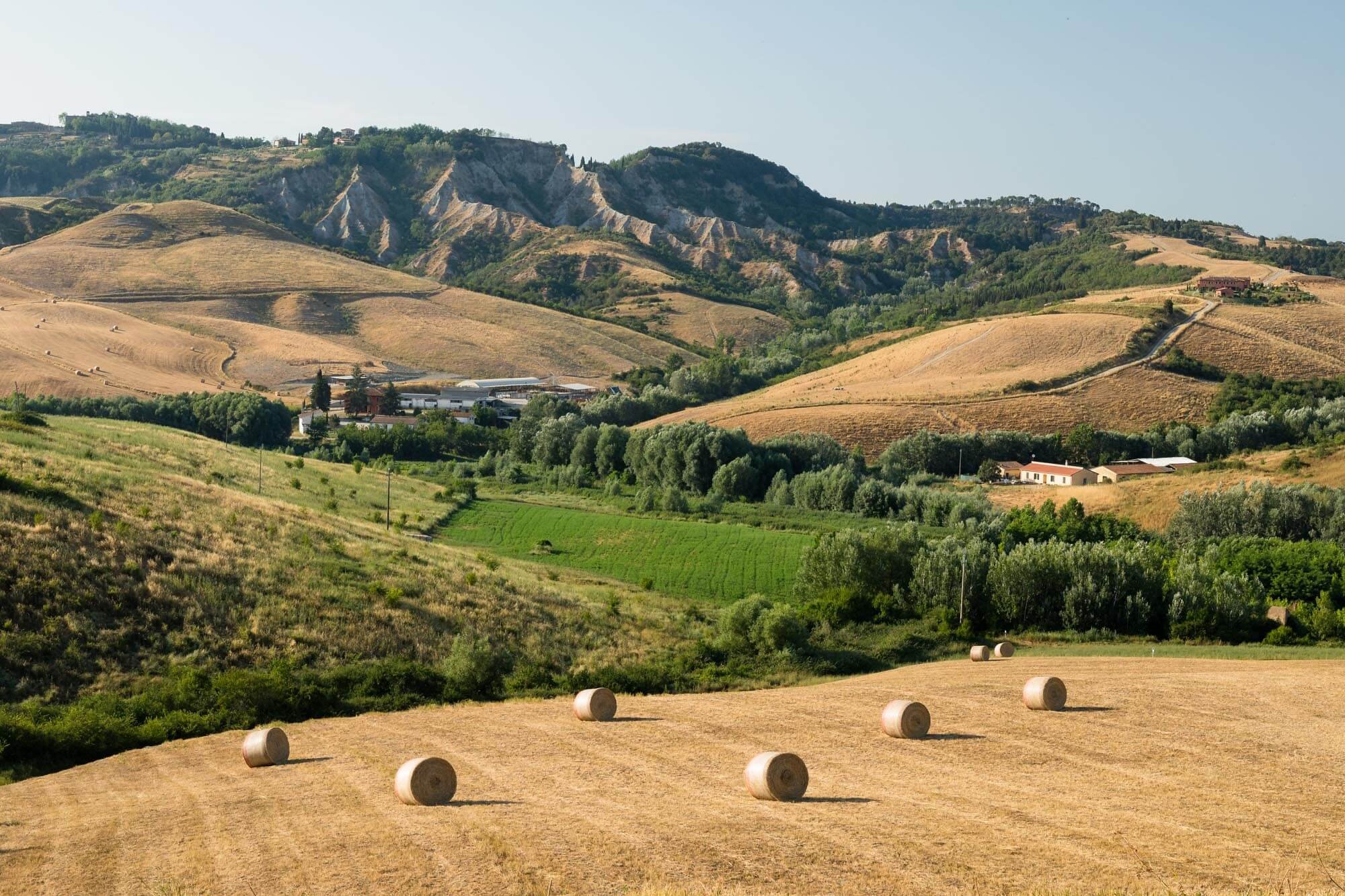 Tuscany hills with hay bales in a rural landscape.