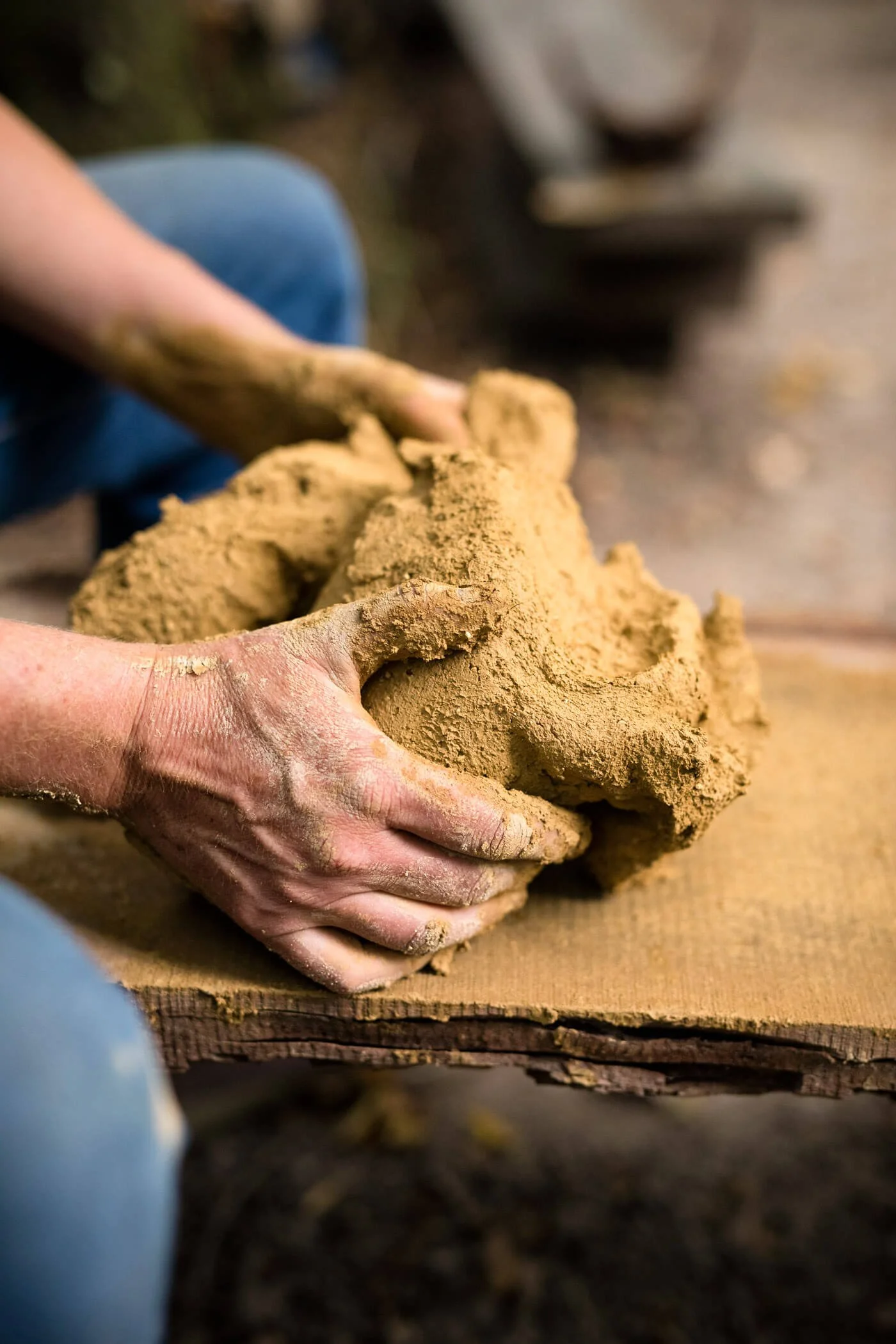 Close-up of Hands Working with Clay on Bench