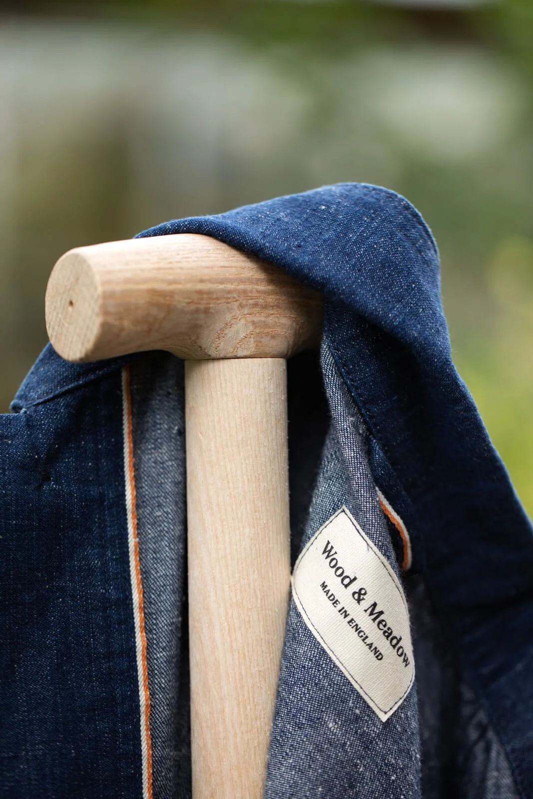 Close-Up of Gardener Jacket Resting On Handle Of Garden Fork