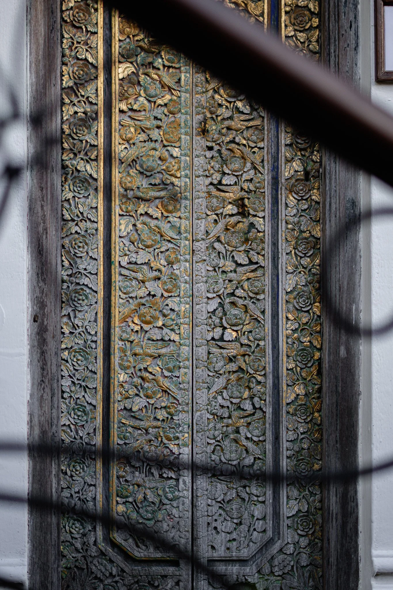 Wooden library door hand carved in the Balinese style.