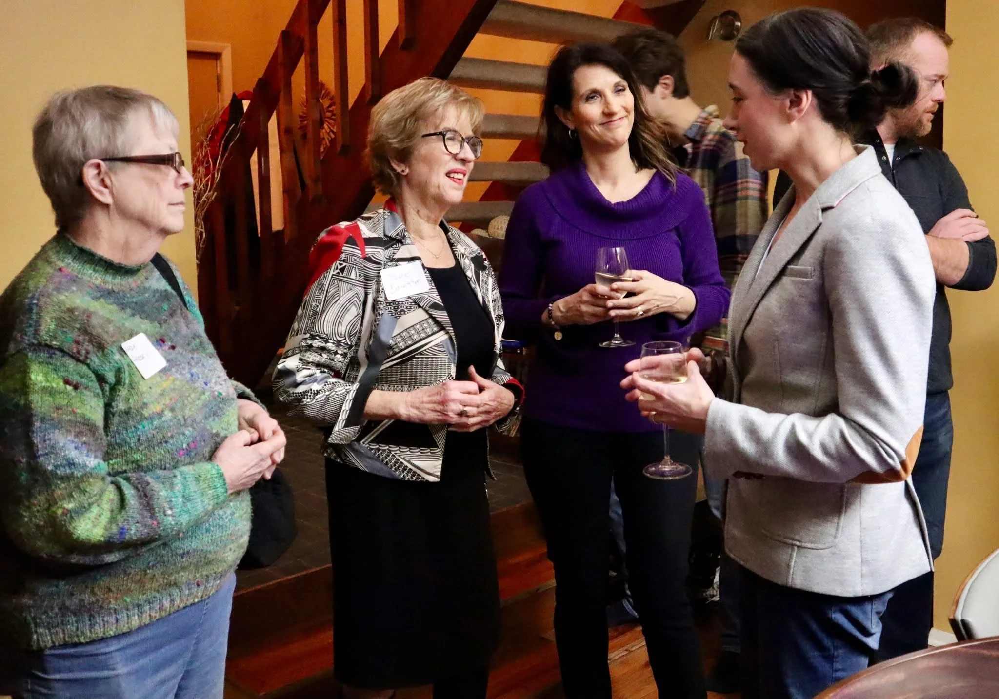 Sara Gullion and Representative Sue Errington speak to constituents at a social gathering. 
