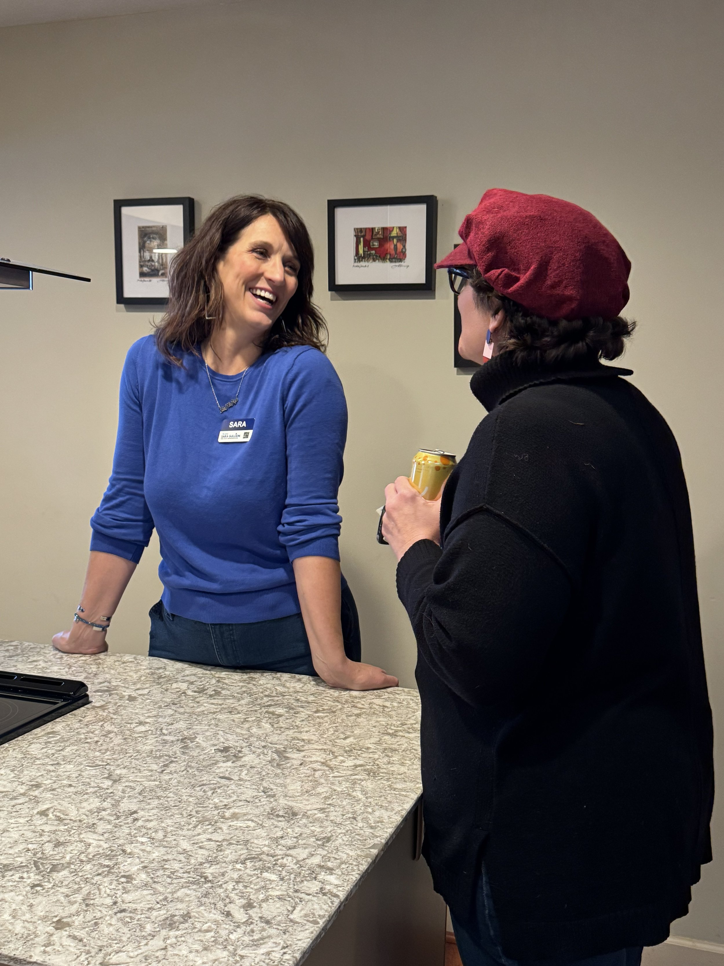 Sara speaks with a constituent at an event.