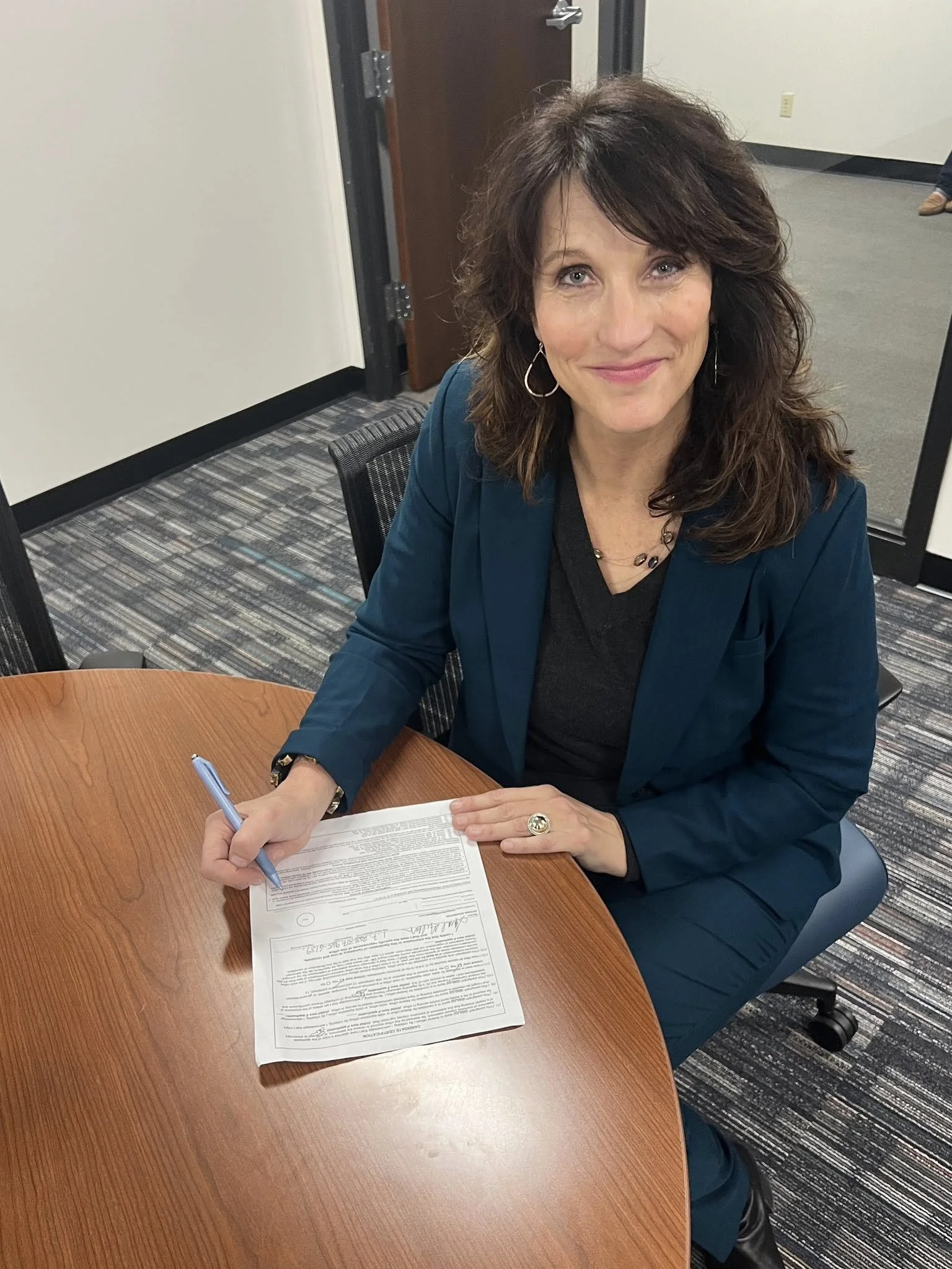 Sara Gullion signs papers for her State Representative Candidacy.