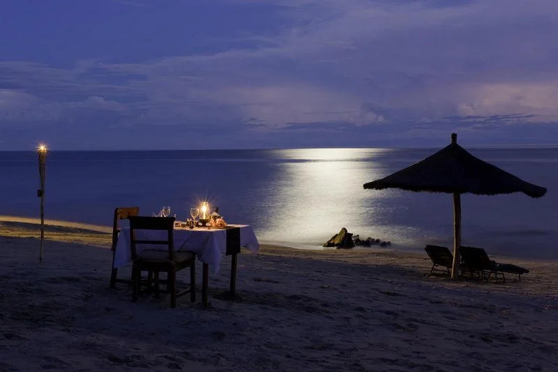 A moonlit table set for two on the Northern Lakeshore, offering a serene lakeside dining experience.