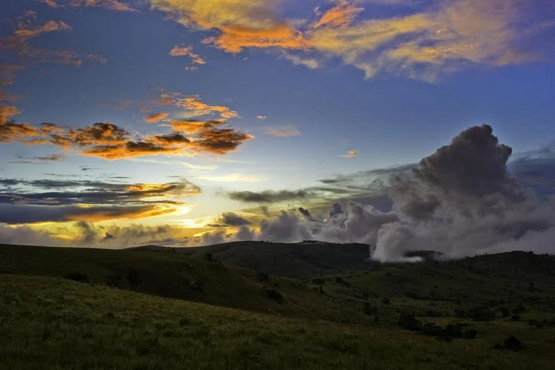 The Nyika Plateau bathed in the golden light of sunset, with clouds rolling over the highlands.