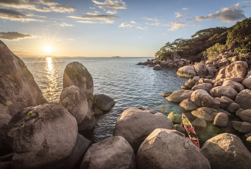 The islands of Lake Malawi National Park glow at sunrise, revealing one of Africa’s most serene landscapes.
