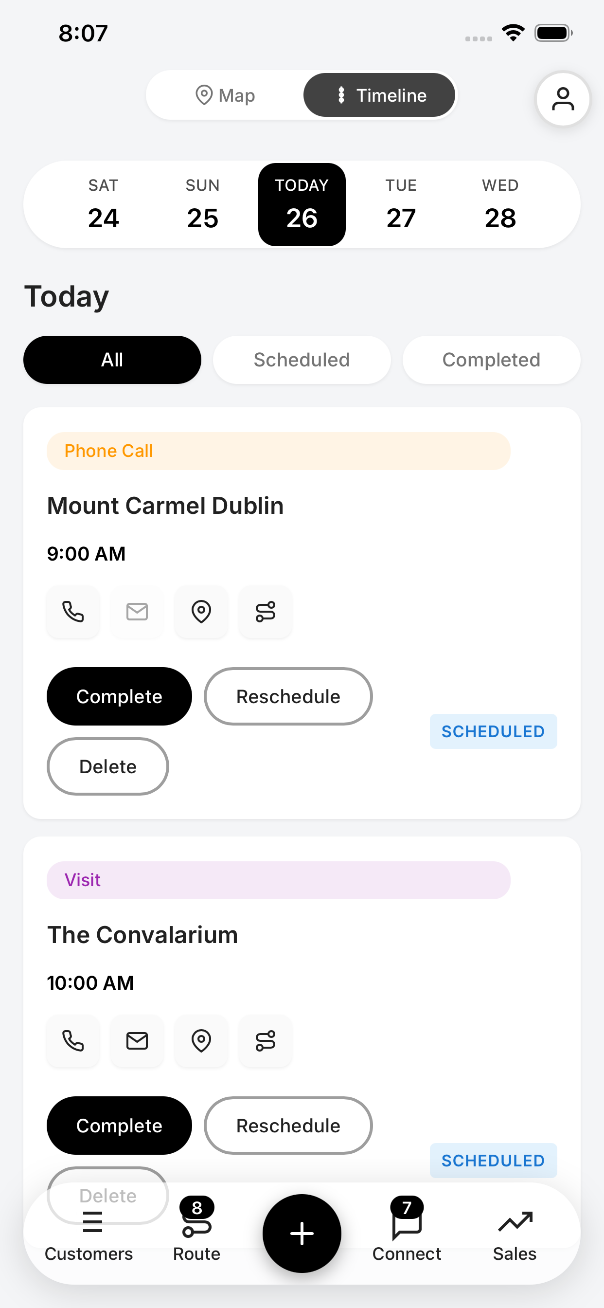 A mobile app interface showing a daily calendar with scheduled events. The current date is the 26th, with events listed for 9:00 AM at Mount Carmel Dublin and 10:00 AM at The Convalarium.
