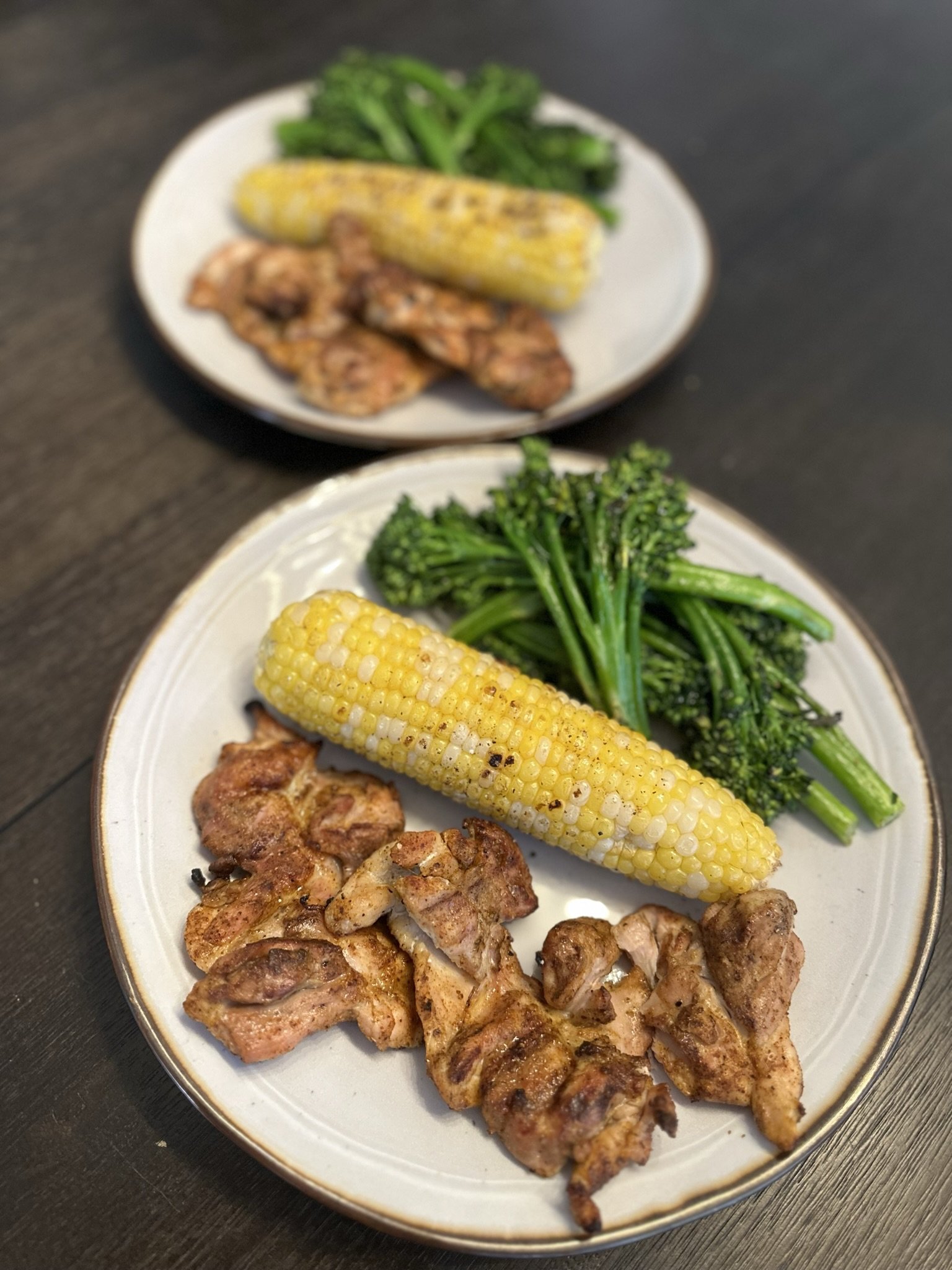 Chicken thighs, corn on the cob, and broccolini
