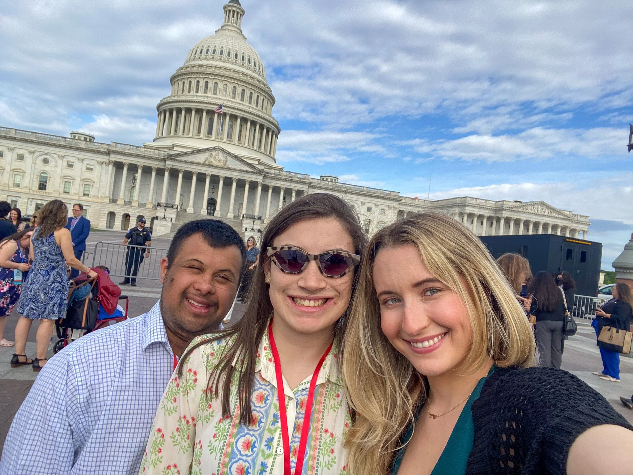 Three advocates standing in front of the Nation's Capital in Washington DC