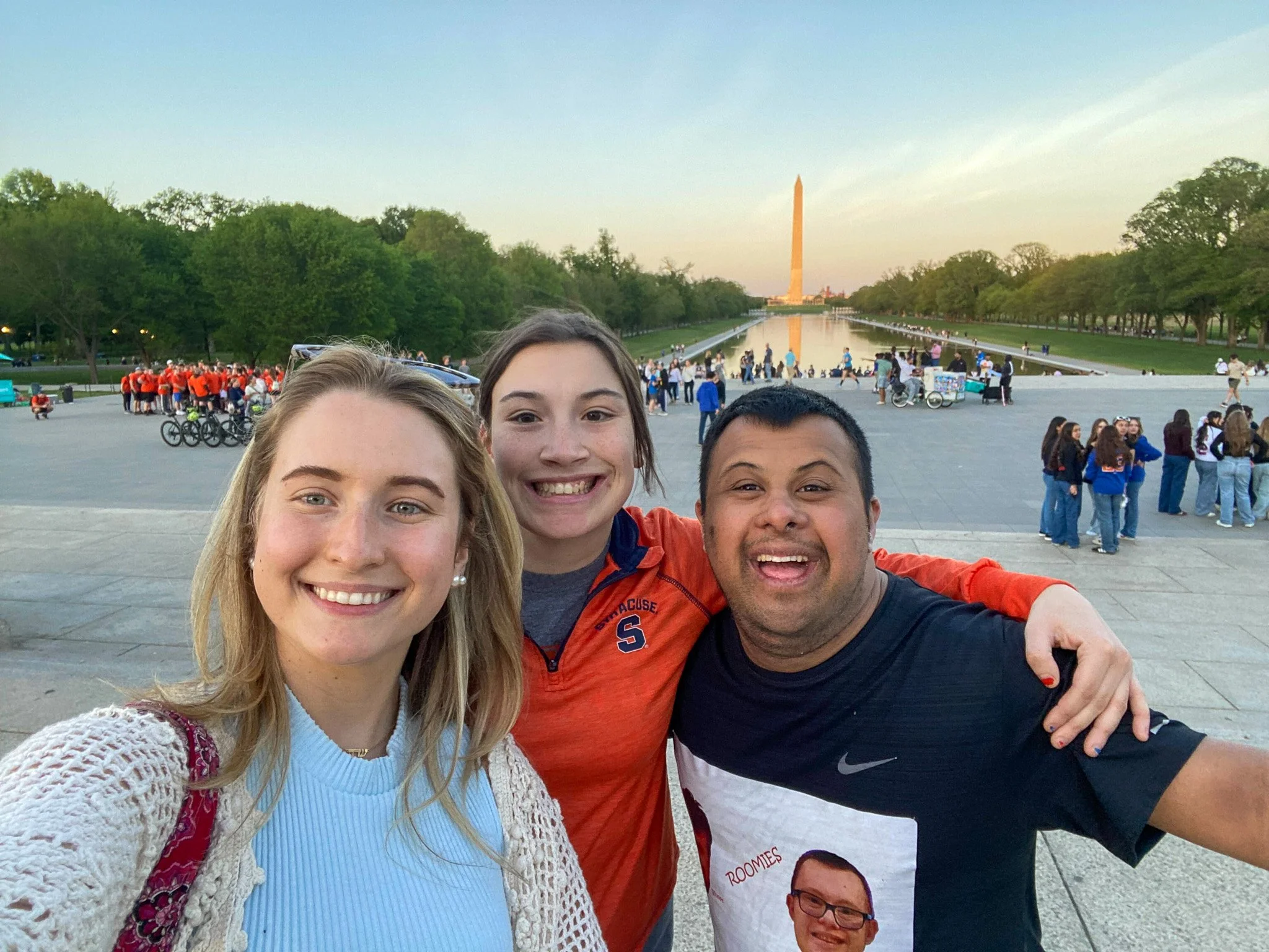 Group of four friends taking a selfie at the National Mall in Washington, D.C., with the Washington Monument in the background.