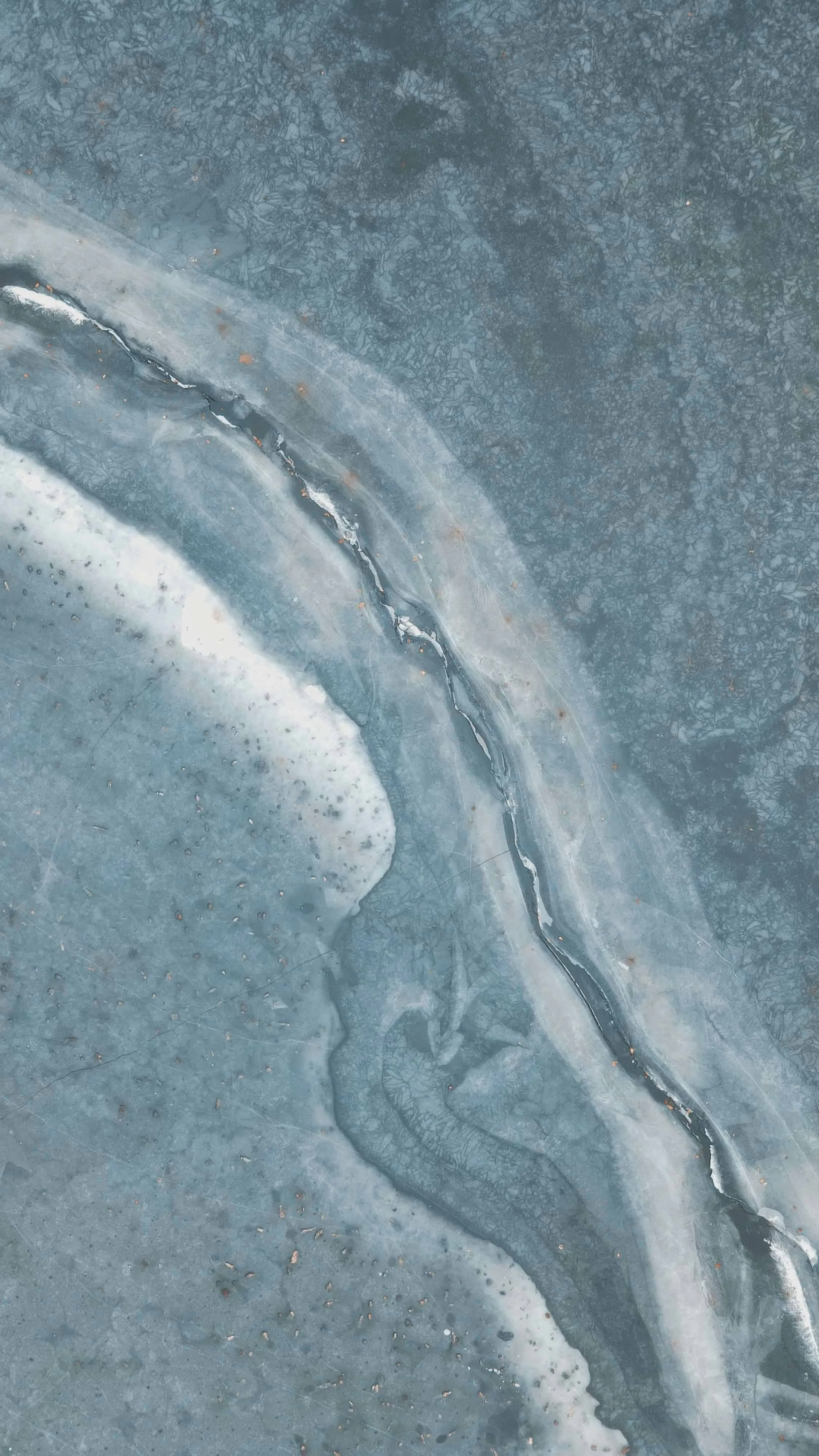 Abstract blue and white stone or ice texture with natural flowing patterns.
