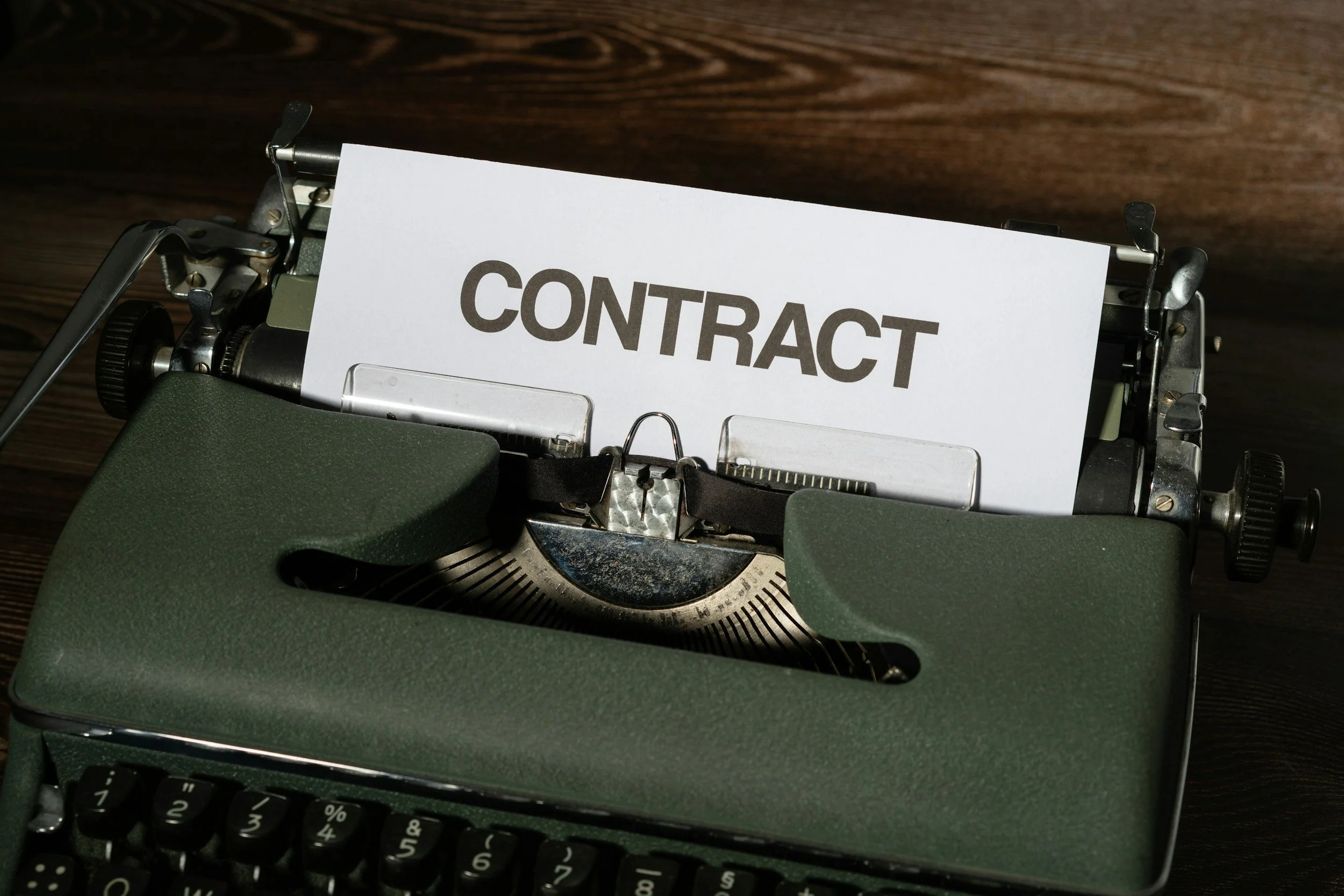 image of a green typewriter with the words 'Contract' 
