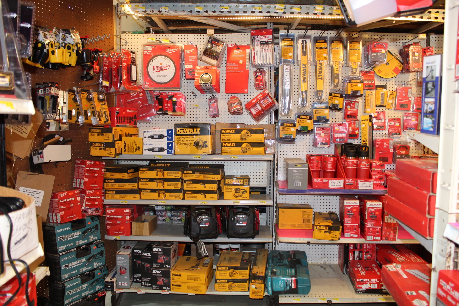 Store shelf with various power tools, hand tools, and accessories in their packaging, primarily in red, yellow, and black colors.