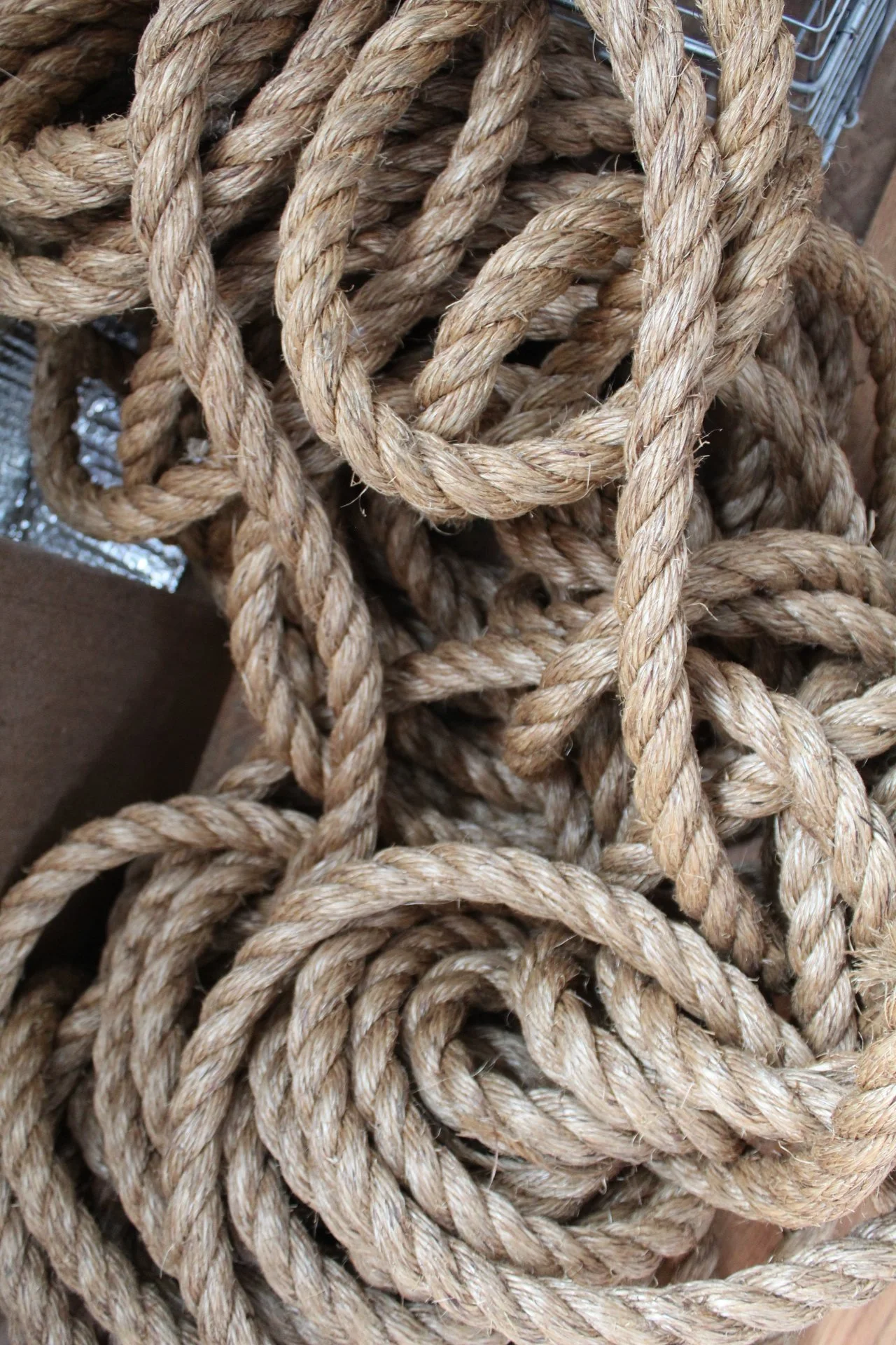 A tangled pile of thick, natural-colored ropes made of twisted fibers.