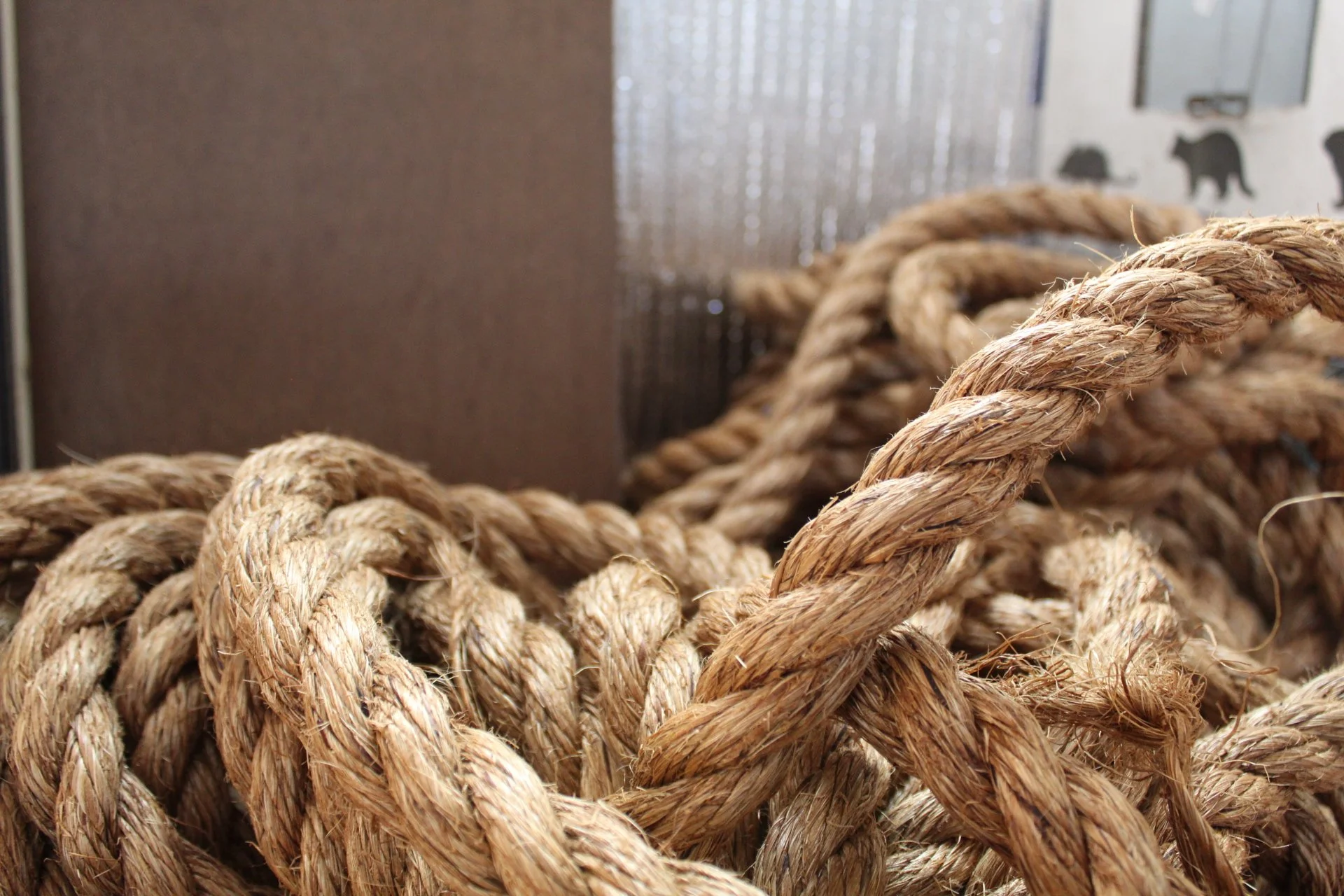 Close-up of thick, coiled, weathered brown rope.
