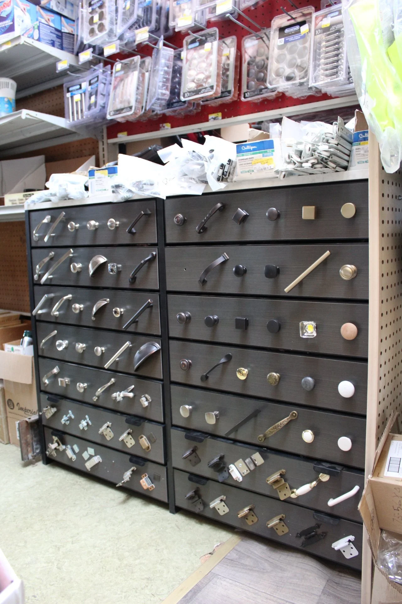 Display of cabinet handles and knobs in a hardware store.