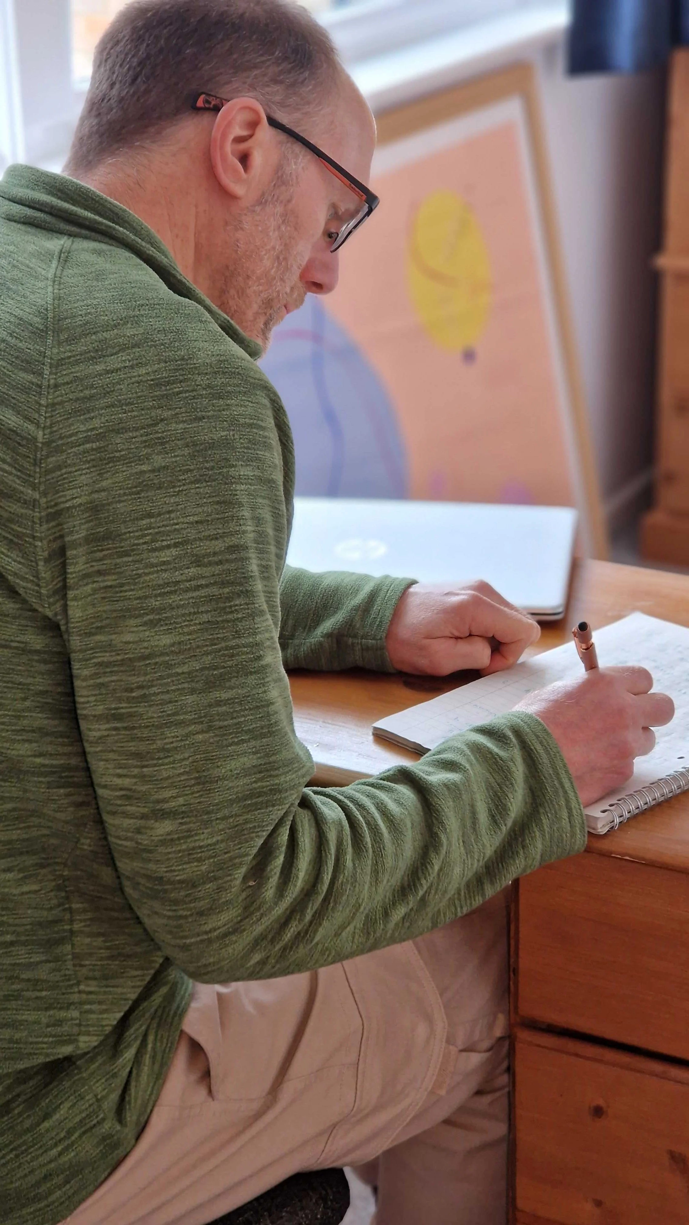Tim Weekes of Tim Weekes Communications Consulting, writing technical marketing content, sitting at writing desk