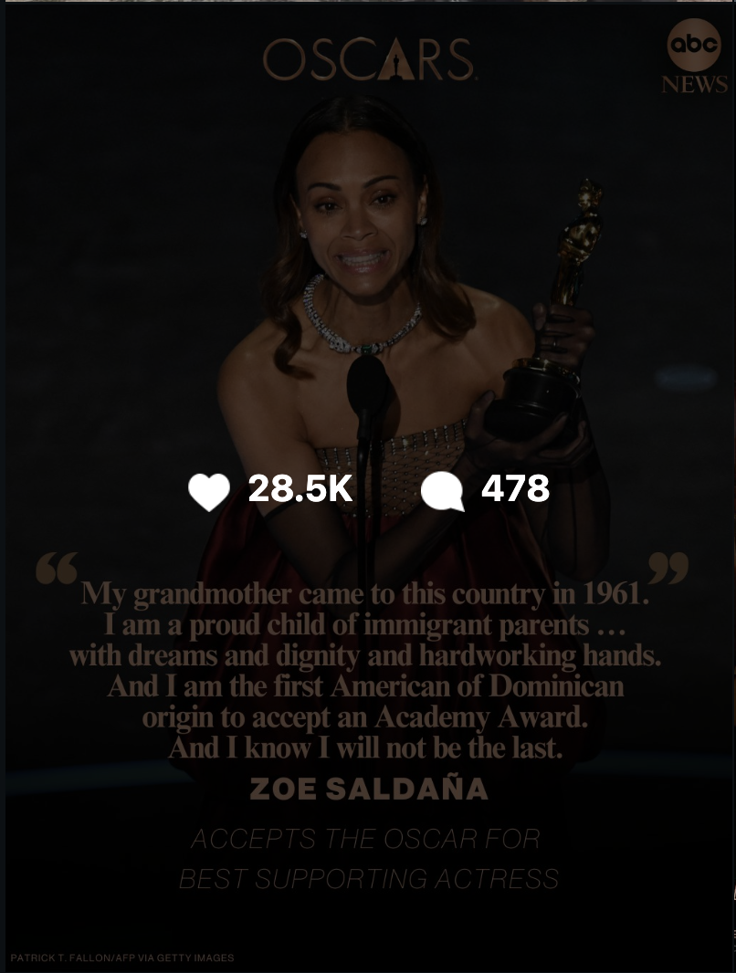 Zoe Saldaña holding an Oscar statue and speaking at an awards ceremony.
