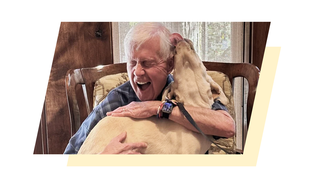 Dave Duffield holding a labrador retriever