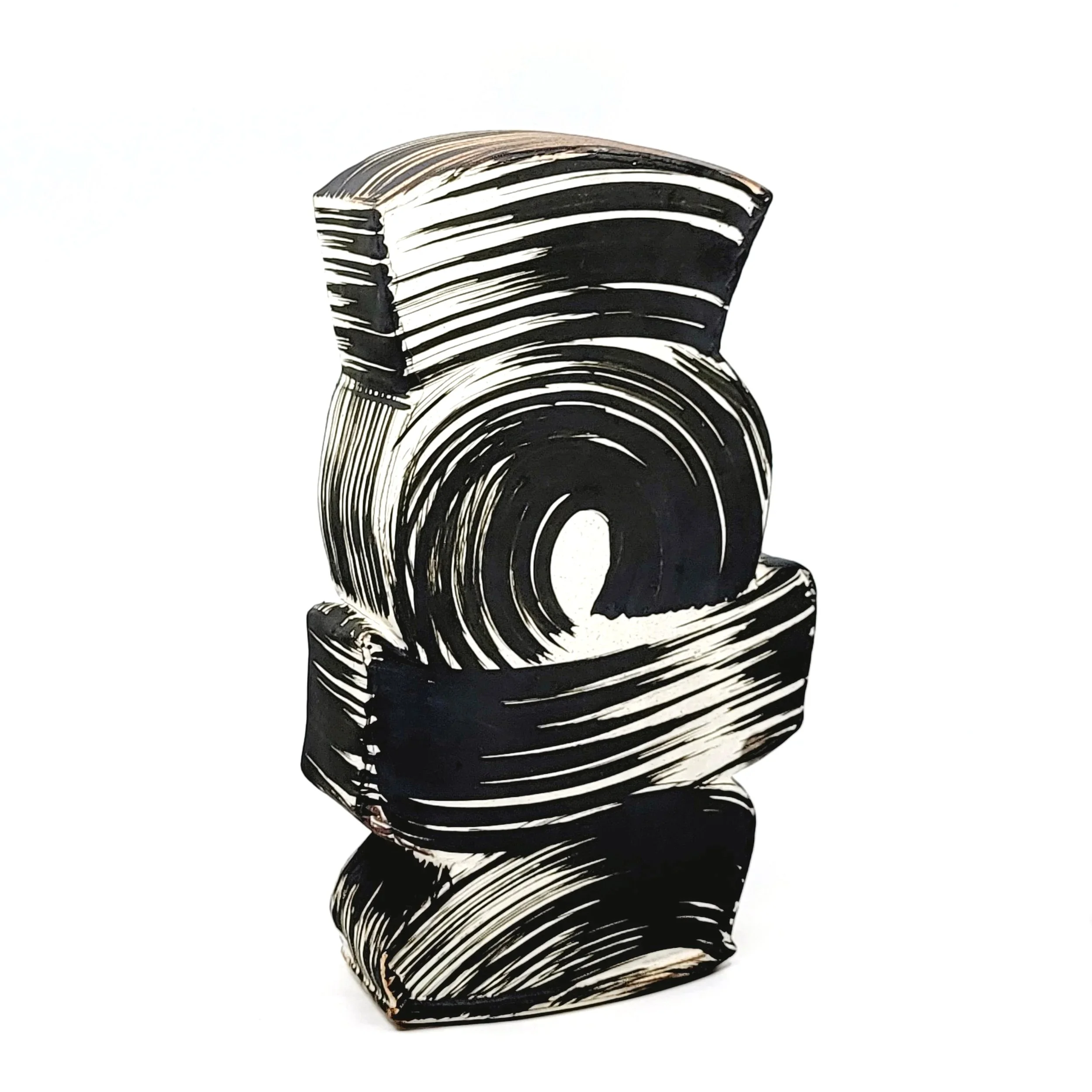 Black and white abstract sculpture with swirling patterns and curved shapes on a white background.
