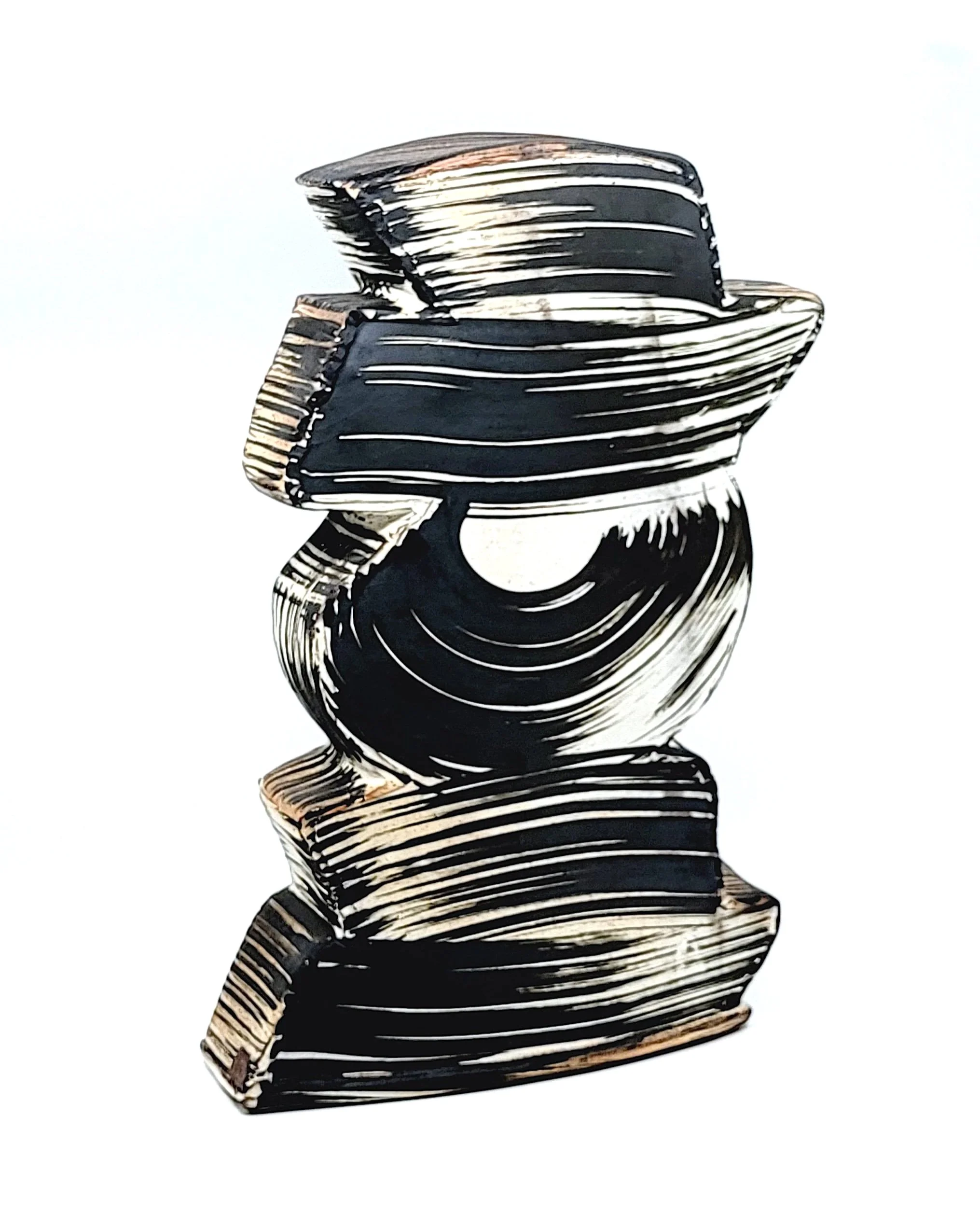 Black and white ceramic sculpture with swirling patterns and geometric shapes.