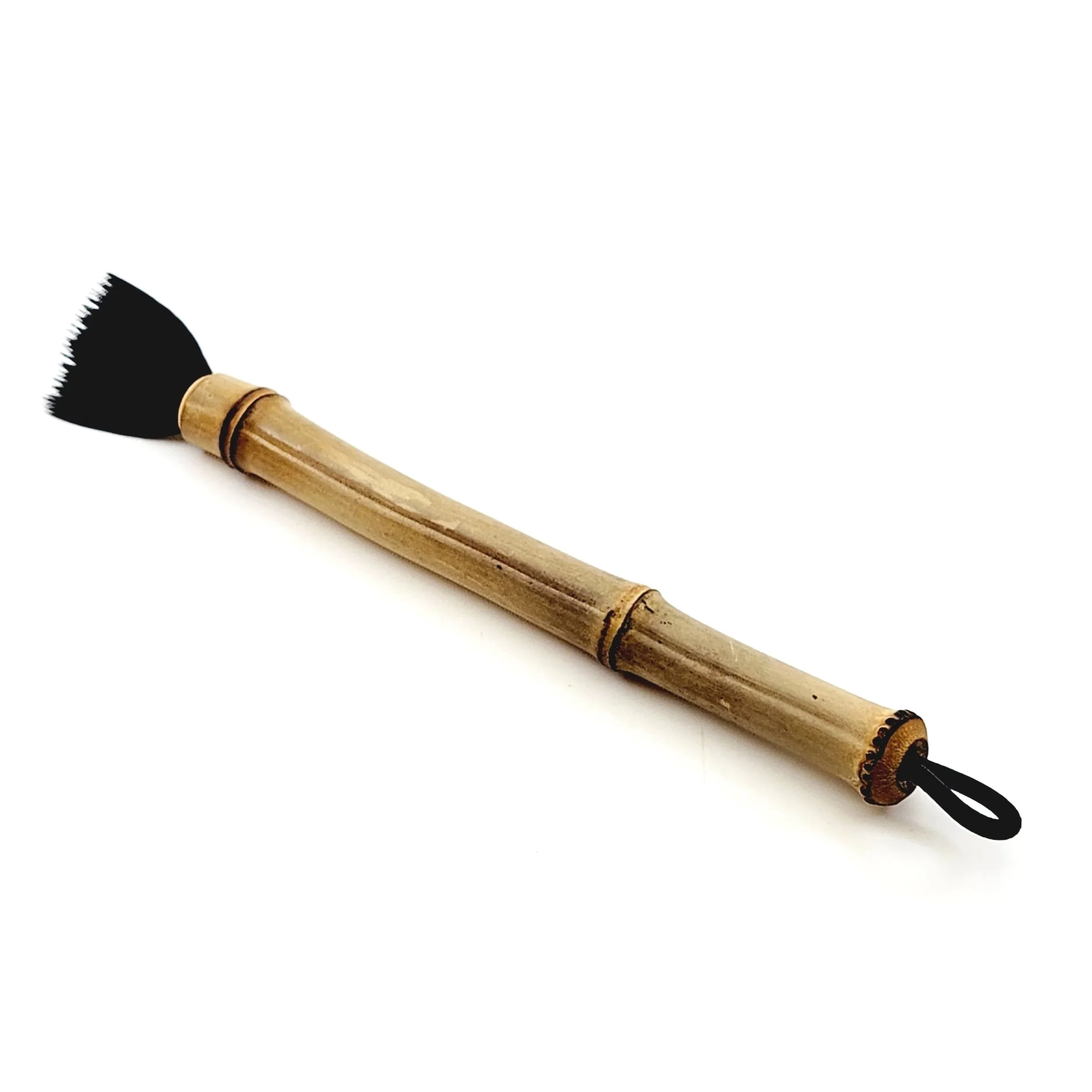 Bamboo makeup brush with black bristles on a white background.